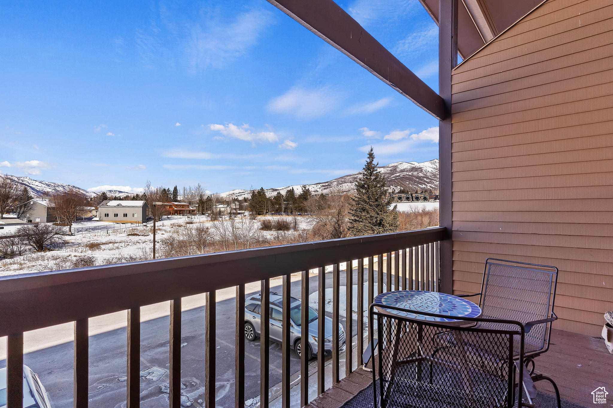 Snow covered back of property featuring a mountain view