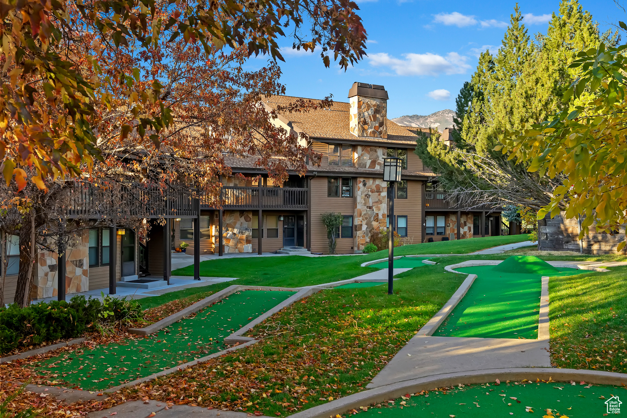 Surrounding community with a mountain view and a yard