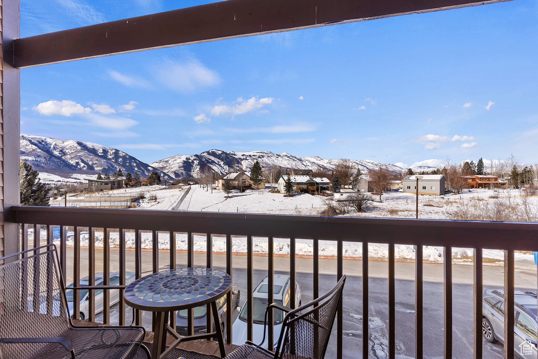 Snow covered back of property with a mountain view