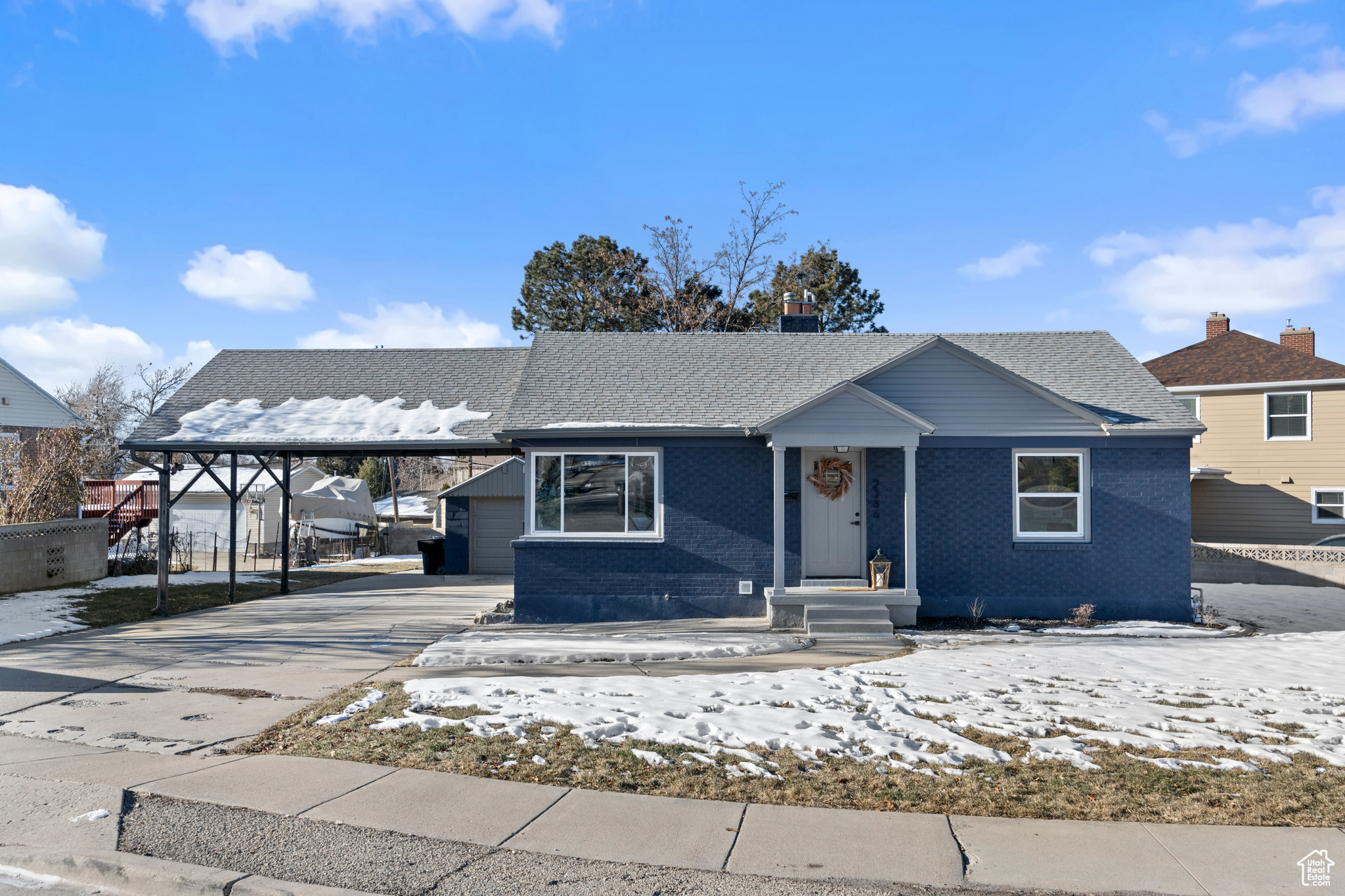 View of front of property with a carport