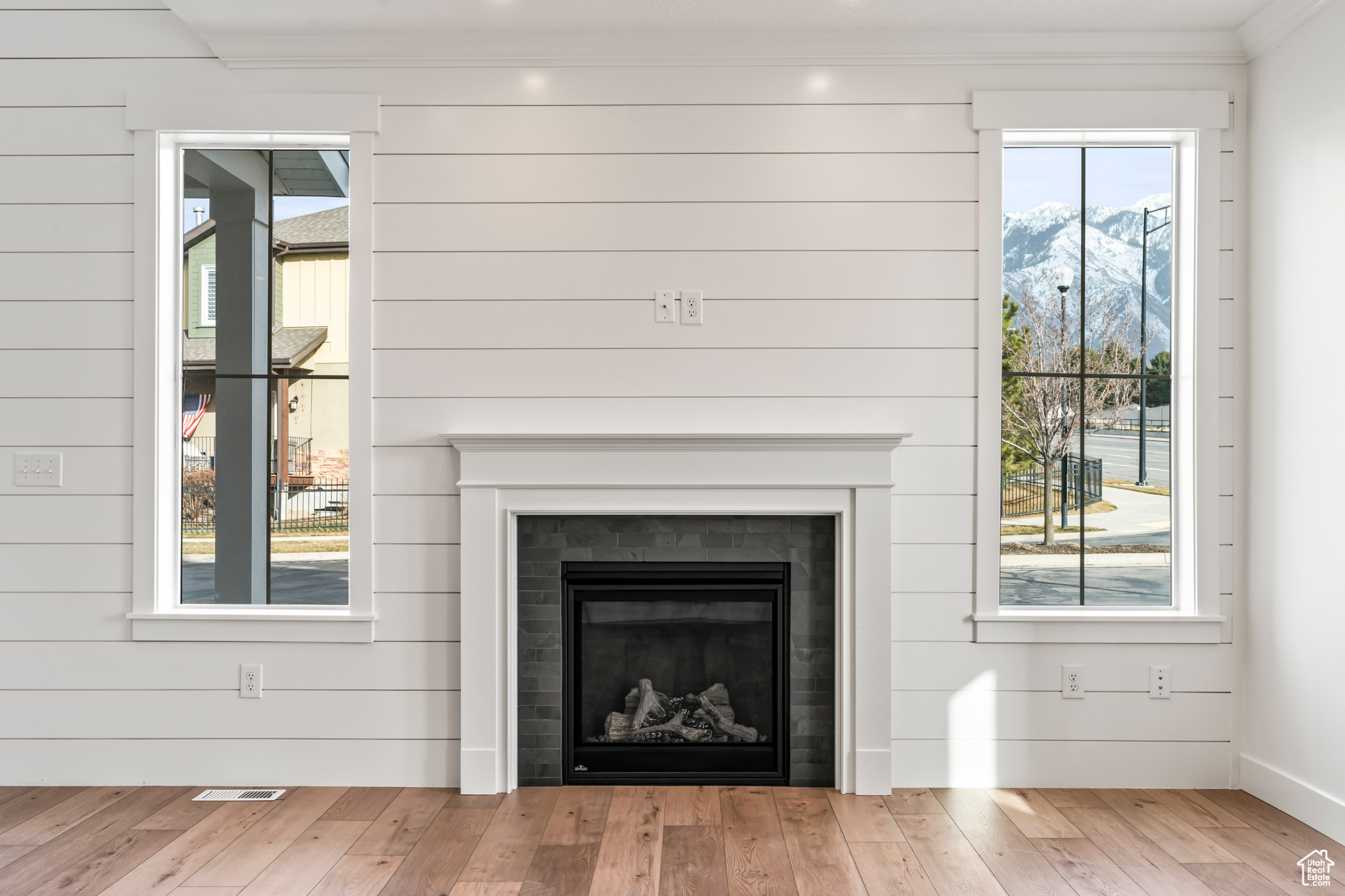 Room details featuring wood-type flooring and a tiled fireplace