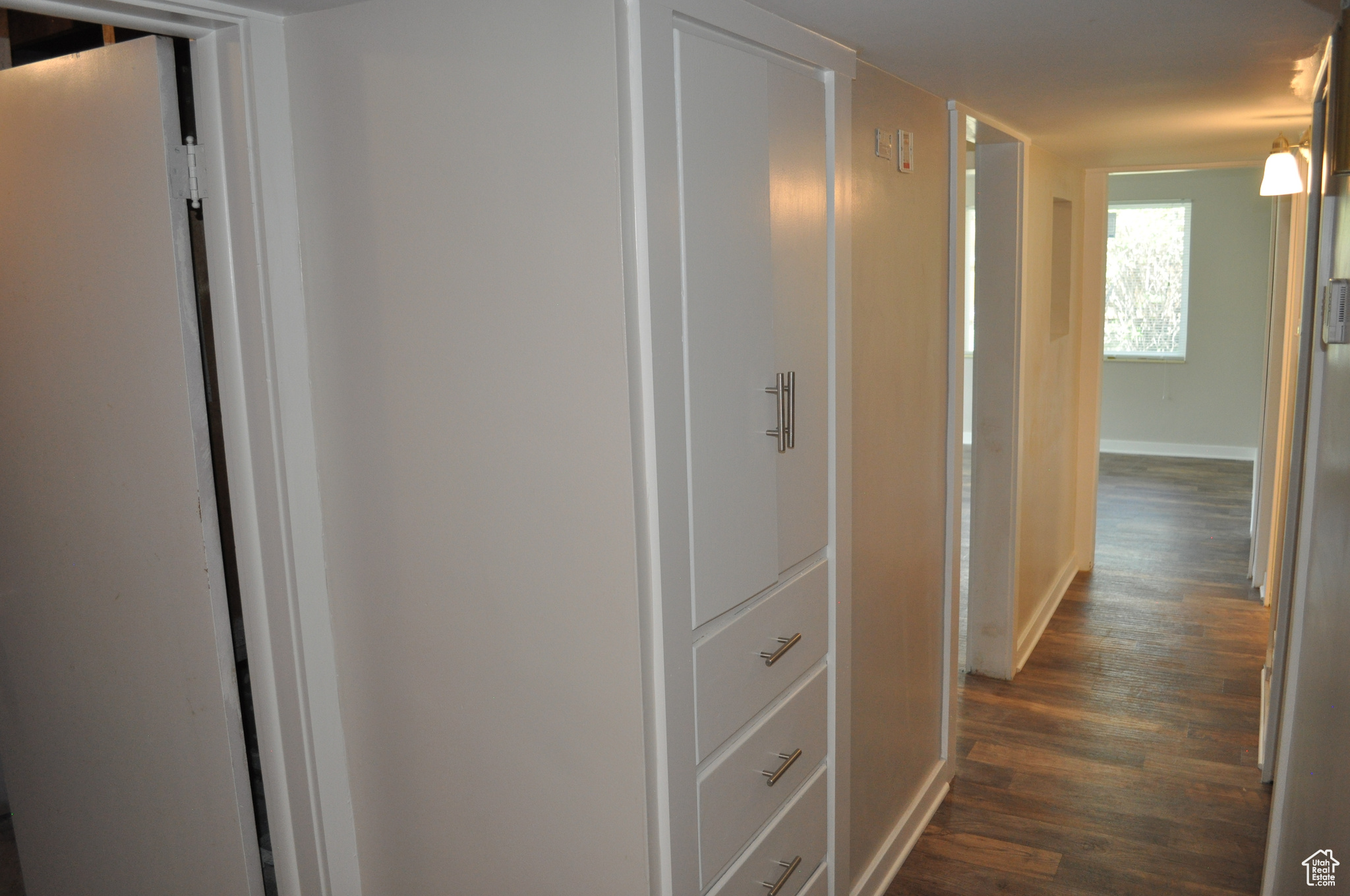 Hallway featuring dark wood-type flooring