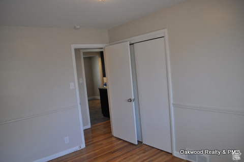 Unfurnished bedroom featuring wood-type flooring and a closet