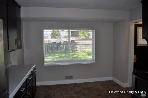 Unfurnished dining area featuring a wealth of natural light