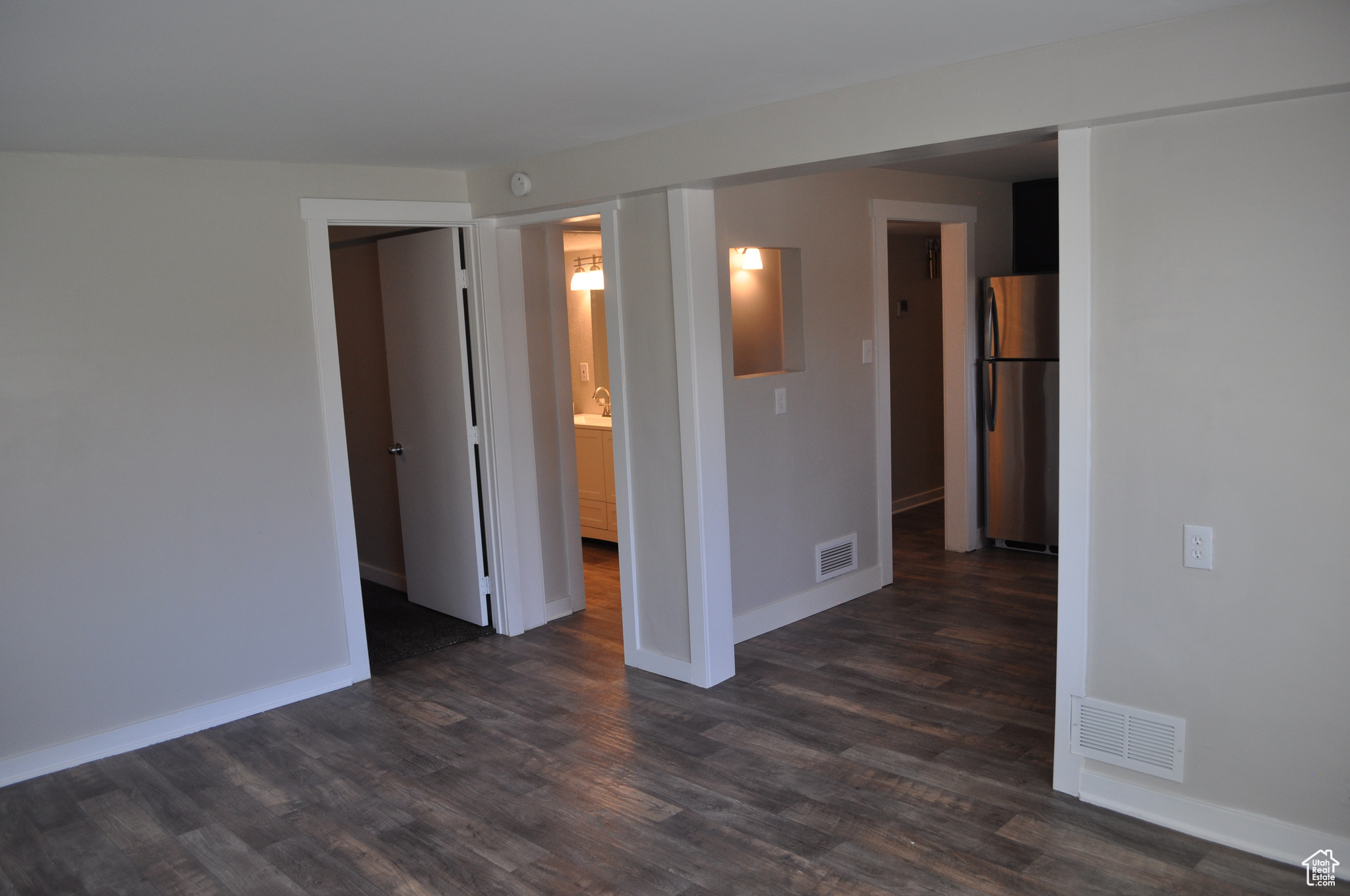 Empty room with dark wood-type flooring