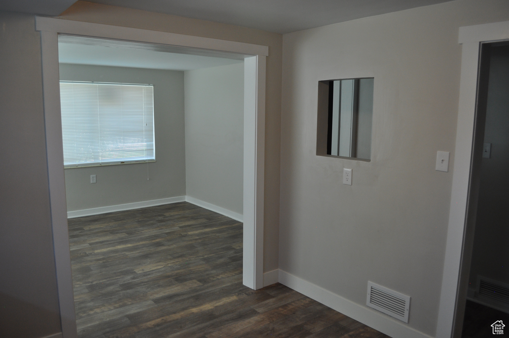 Hallway with dark wood-type flooring