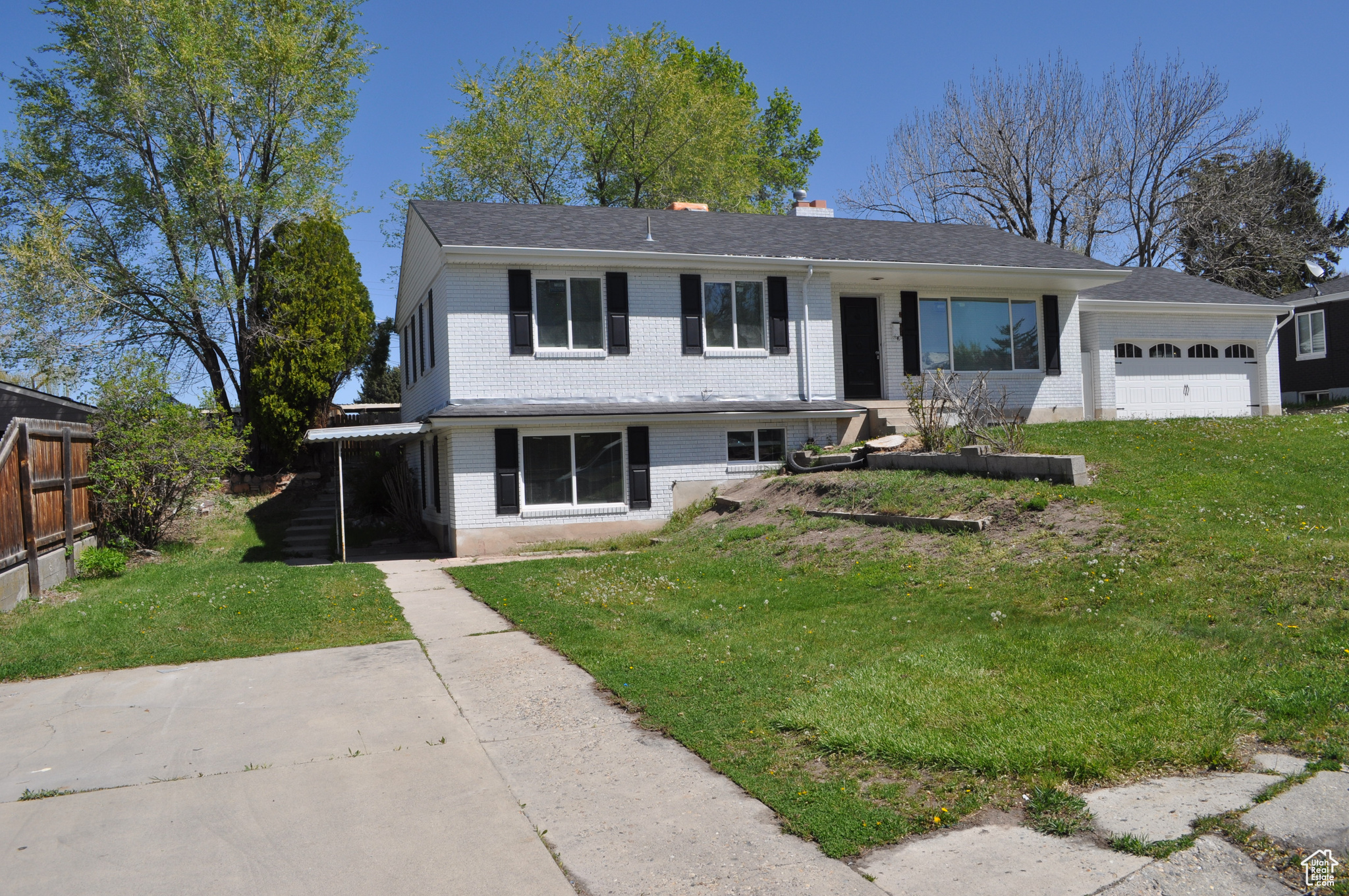 View of front facade with a garage and a front lawn