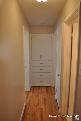 Hallway with light hardwood / wood-style flooring