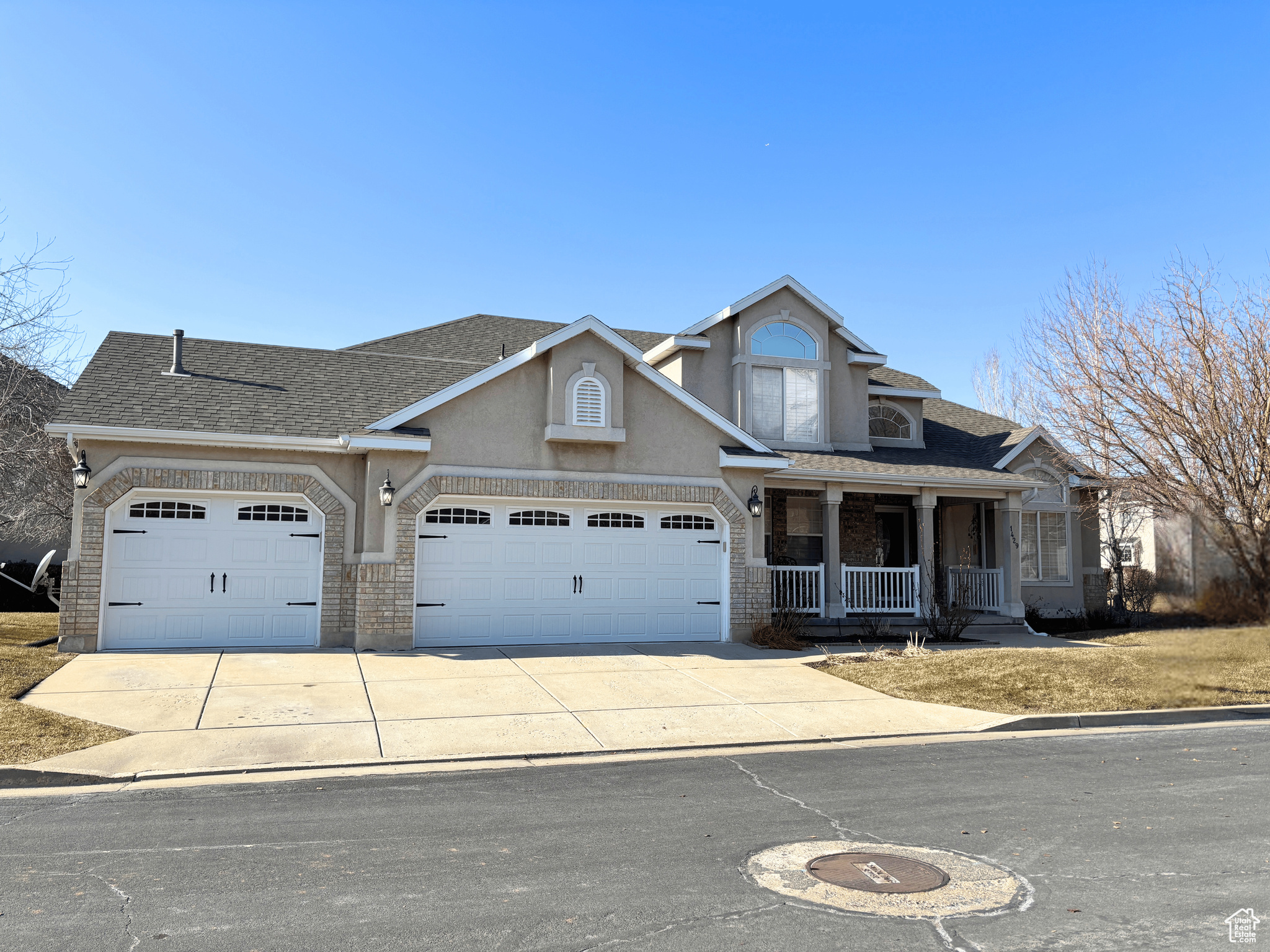 View of front of property featuring a garage and covered porch