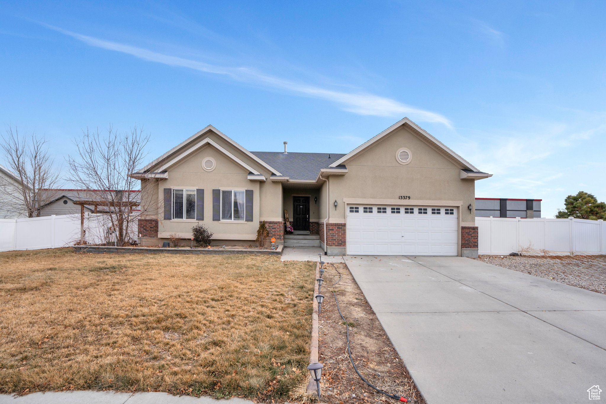 View of front of property with a garage and a front yard