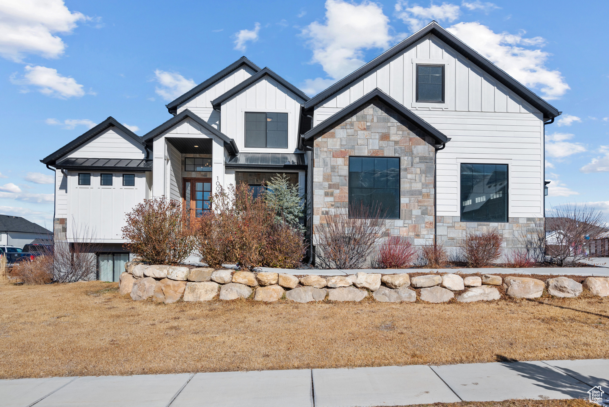 Modern inspired farmhouse with a front yard