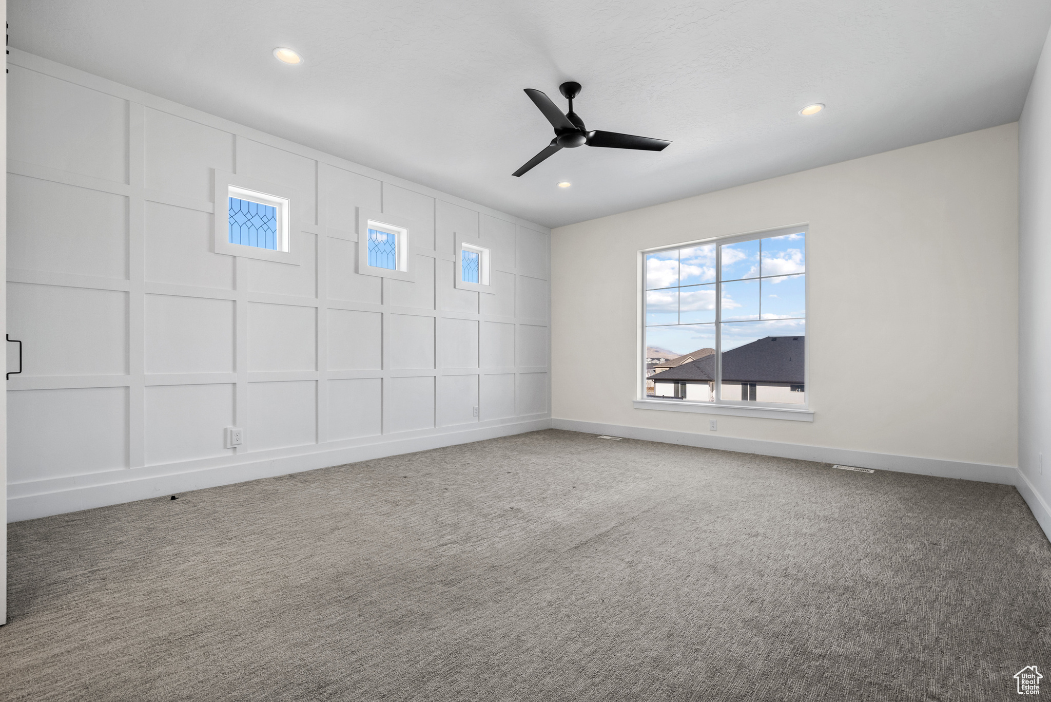 Spare room featuring carpet floors and ceiling fan