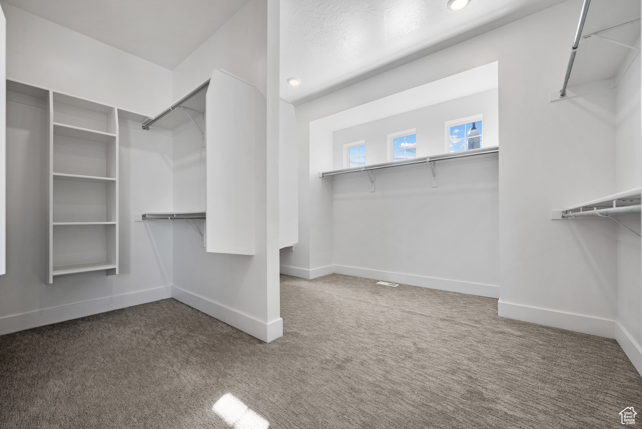 Spacious closet with carpet flooring