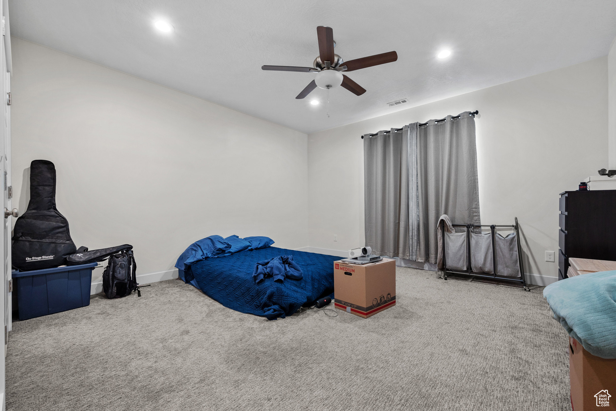 Bedroom featuring ceiling fan and carpet