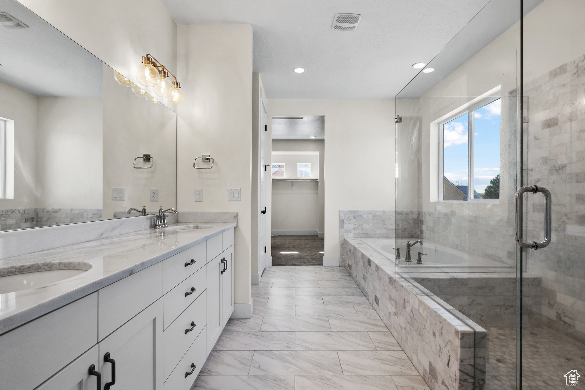 Bathroom with vanity and shower with separate bathtub