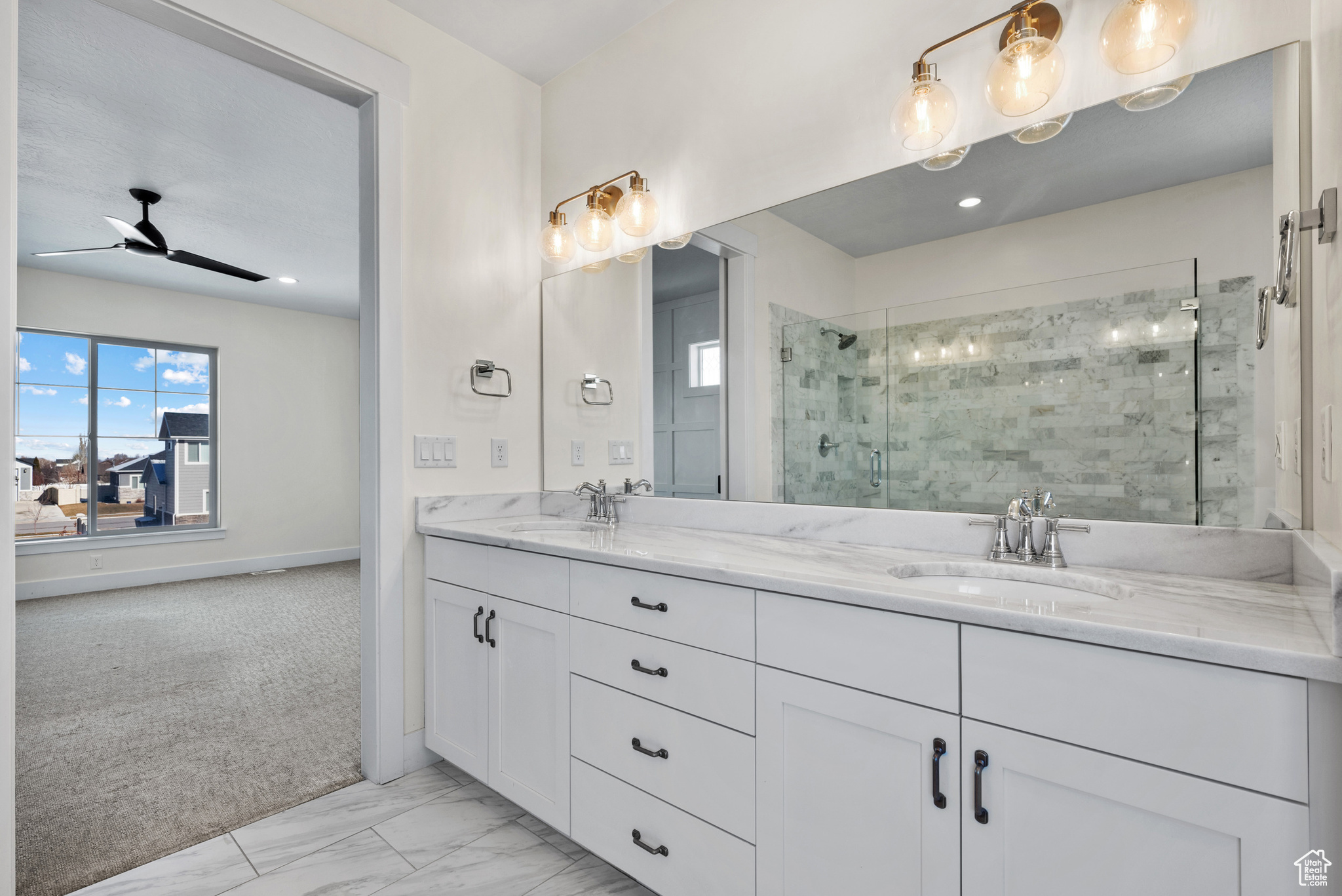 Bathroom with walk in shower, ceiling fan, and vanity