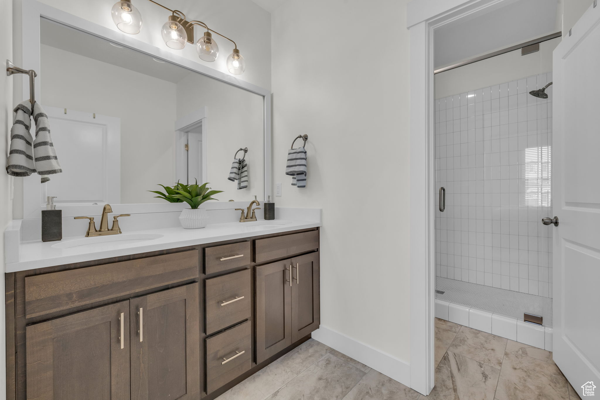 Bathroom featuring vanity and tiled shower