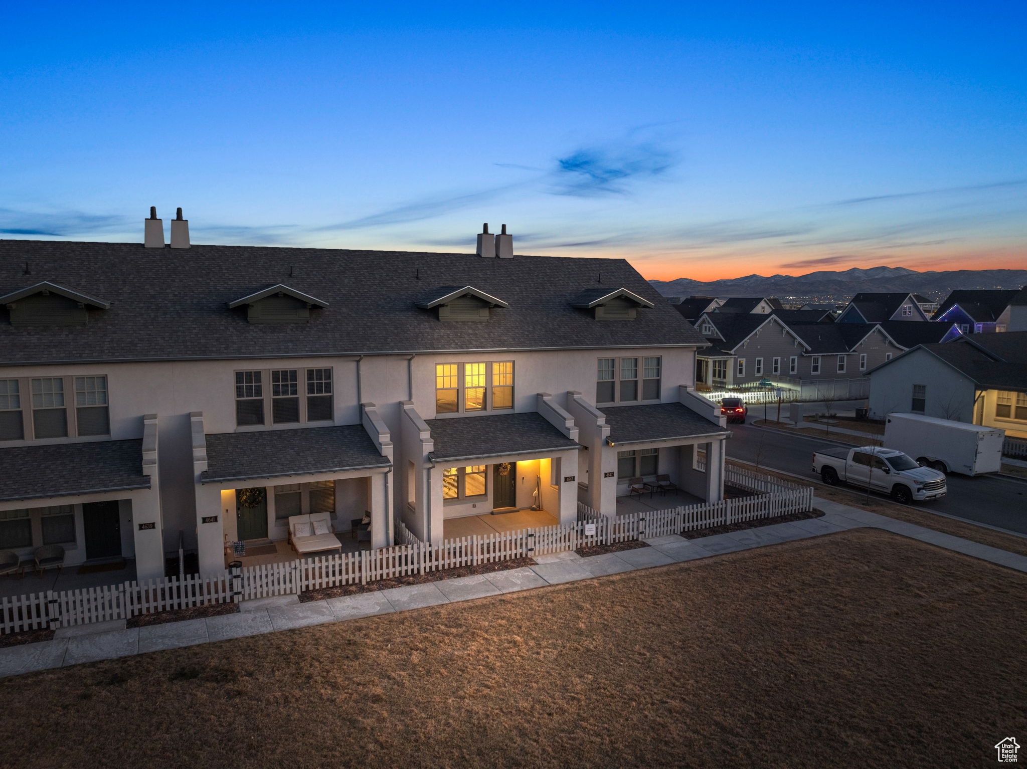 Back house at dusk featuring a patio