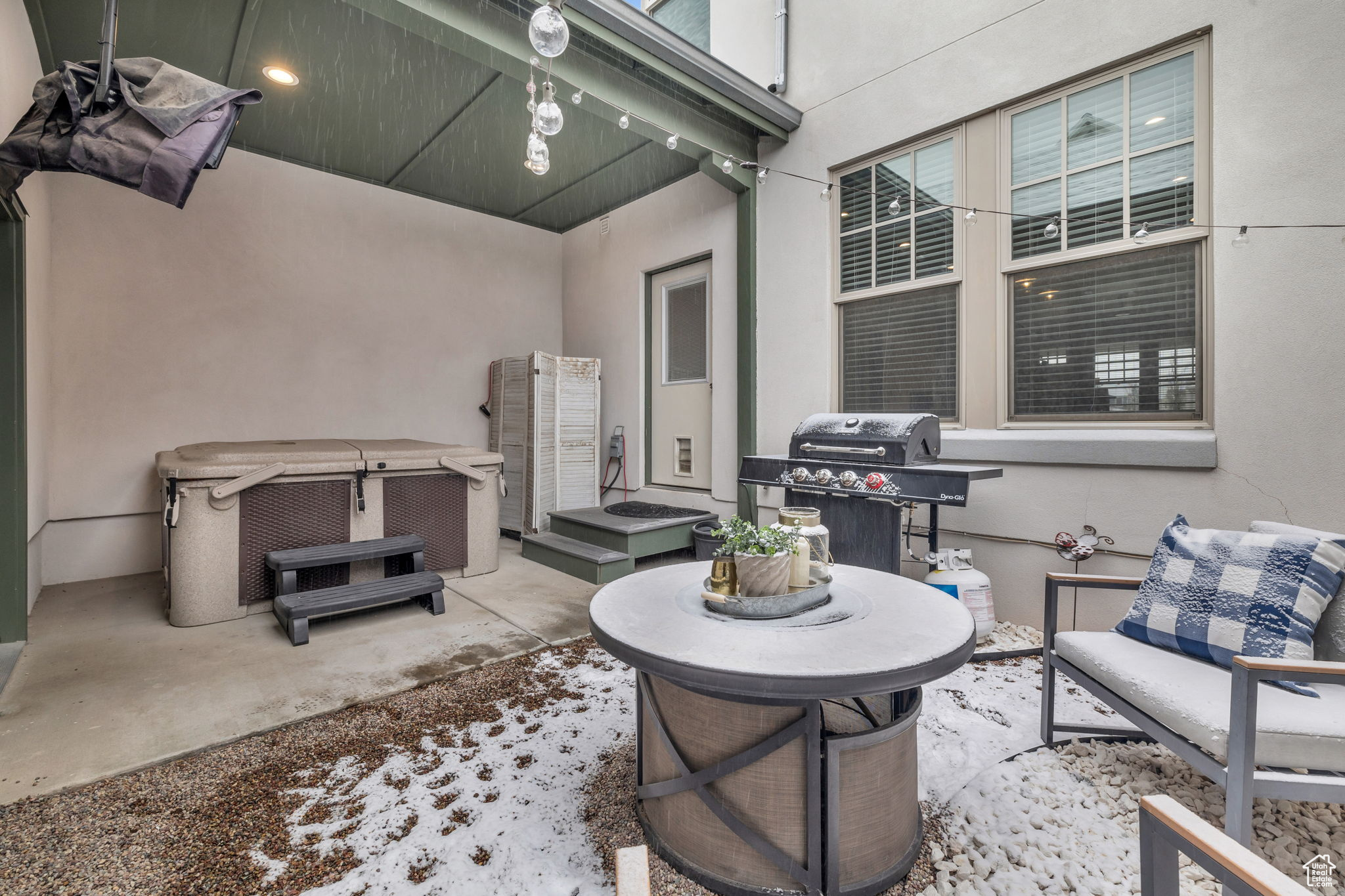 View of patio featuring a hot tub and a grill