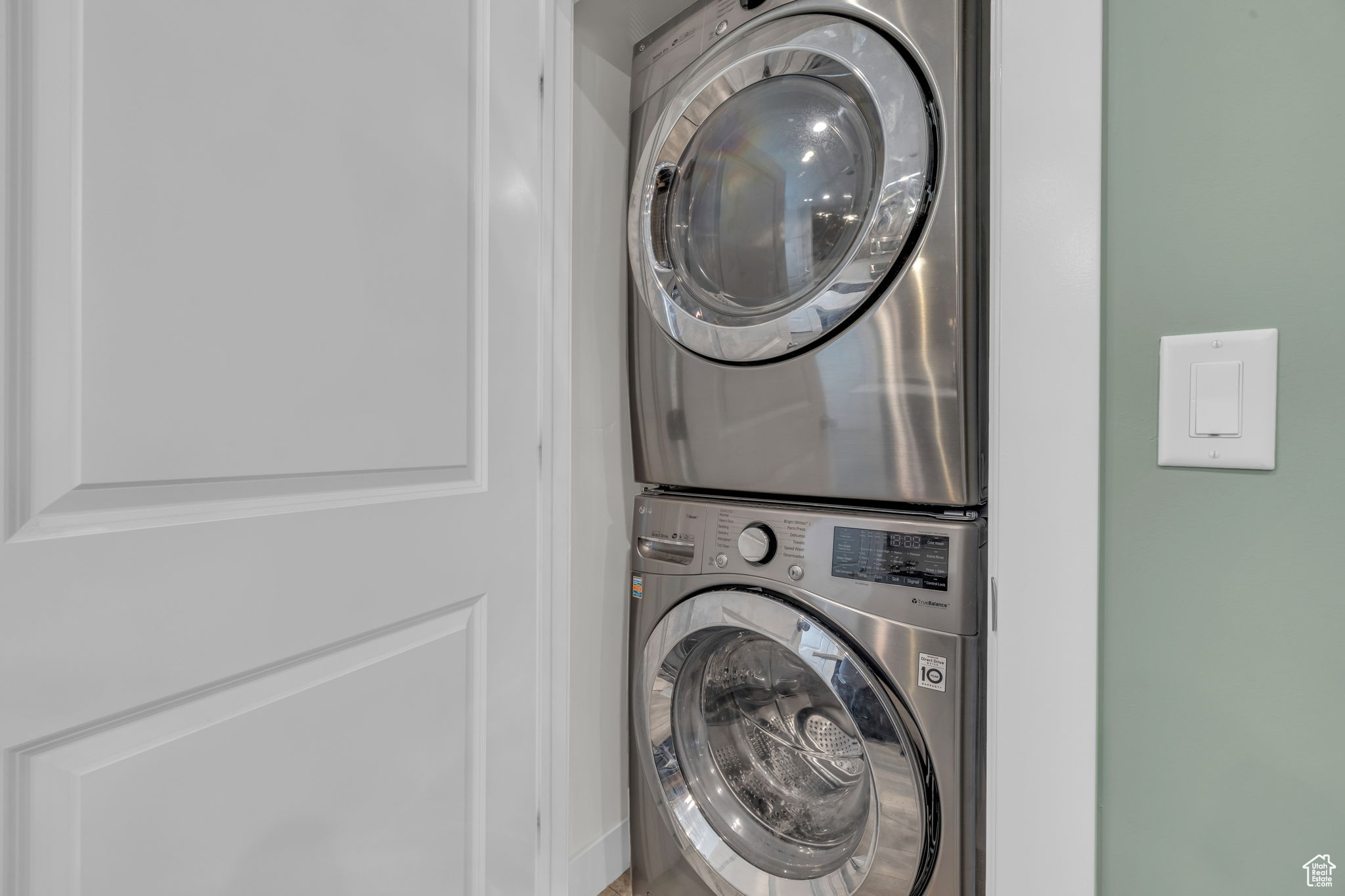 Washroom featuring stacked washer and dryer