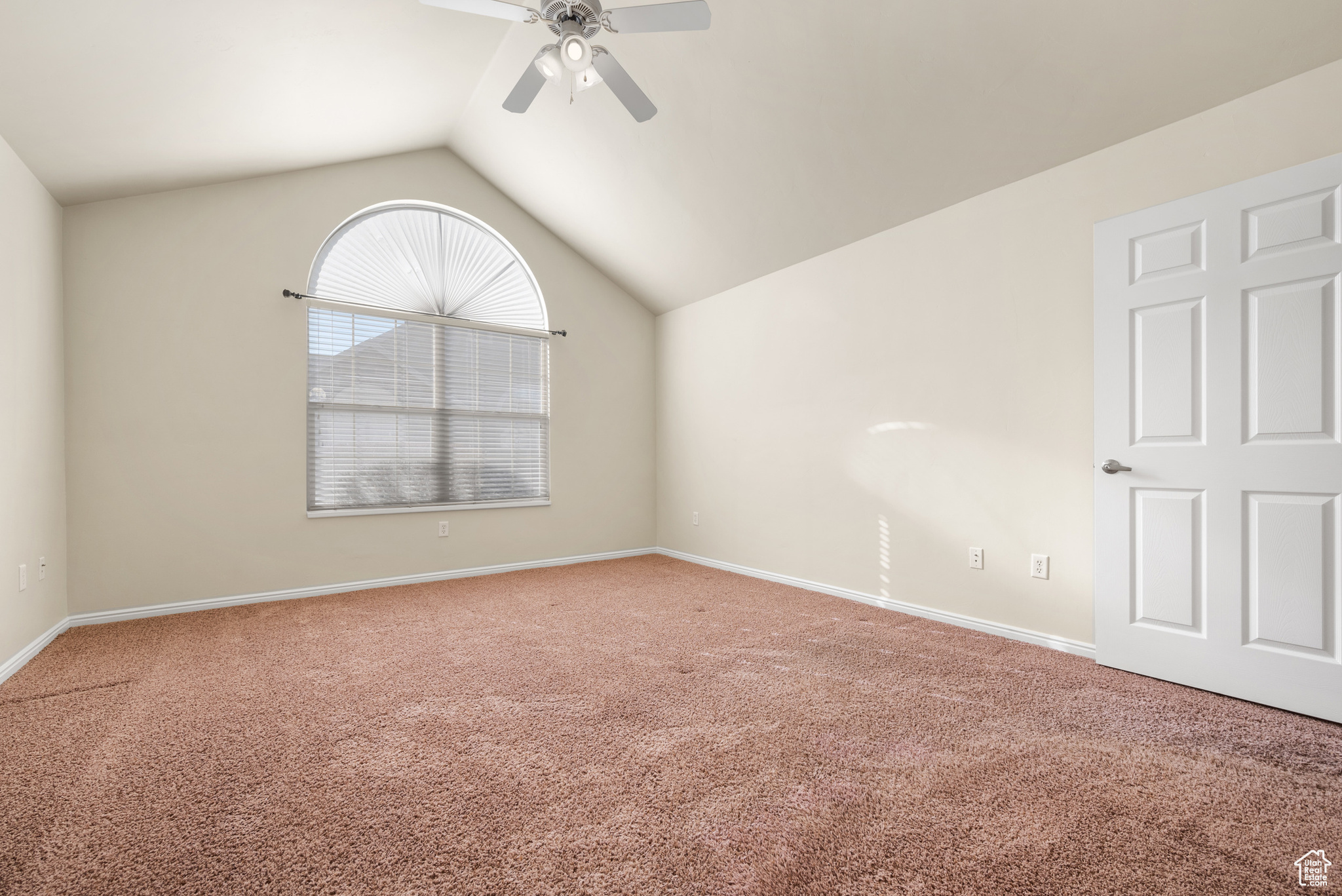 Unfurnished room with lofted ceiling, carpet flooring, and ceiling fan