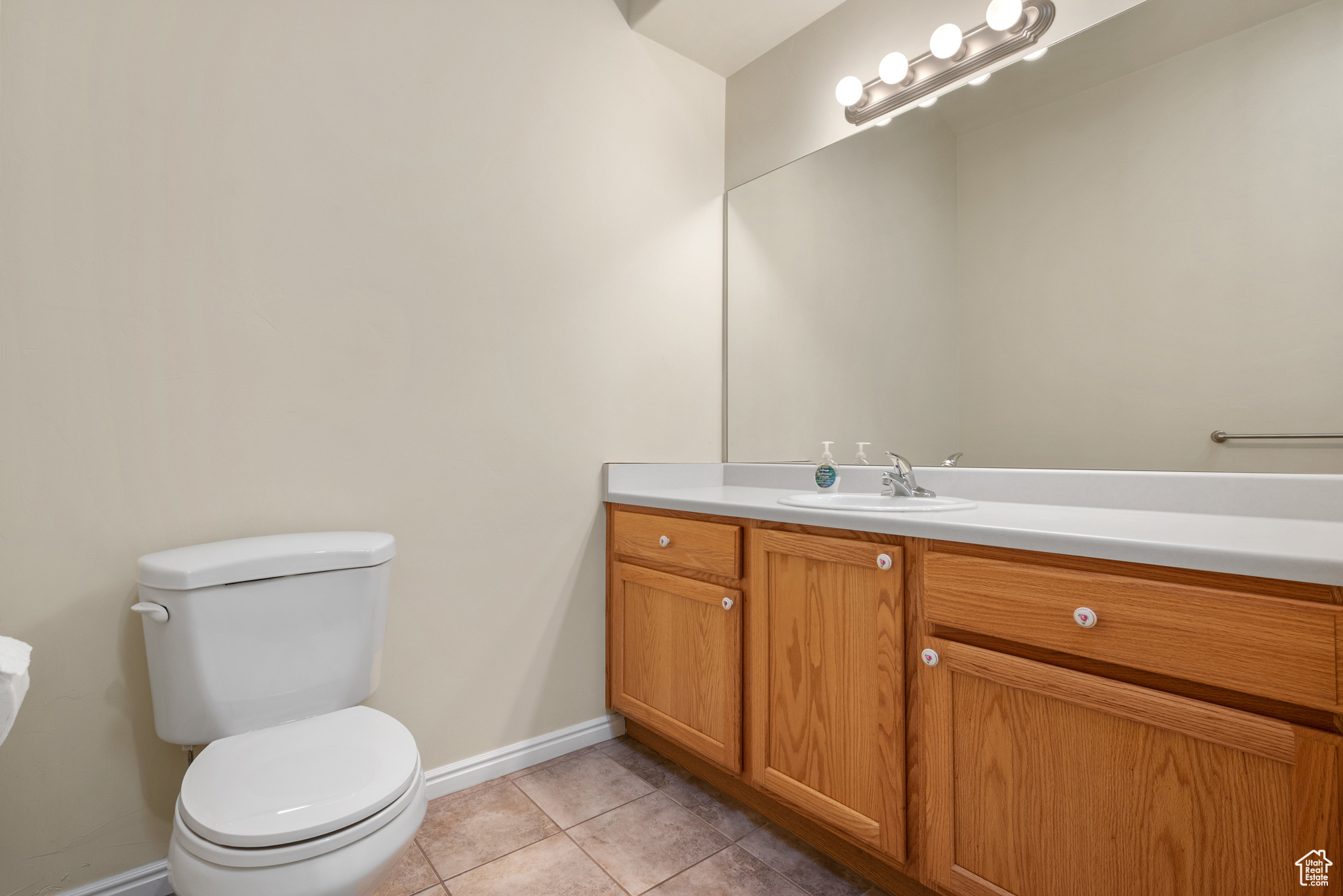 Bathroom with tile patterned flooring, vanity, and toilet