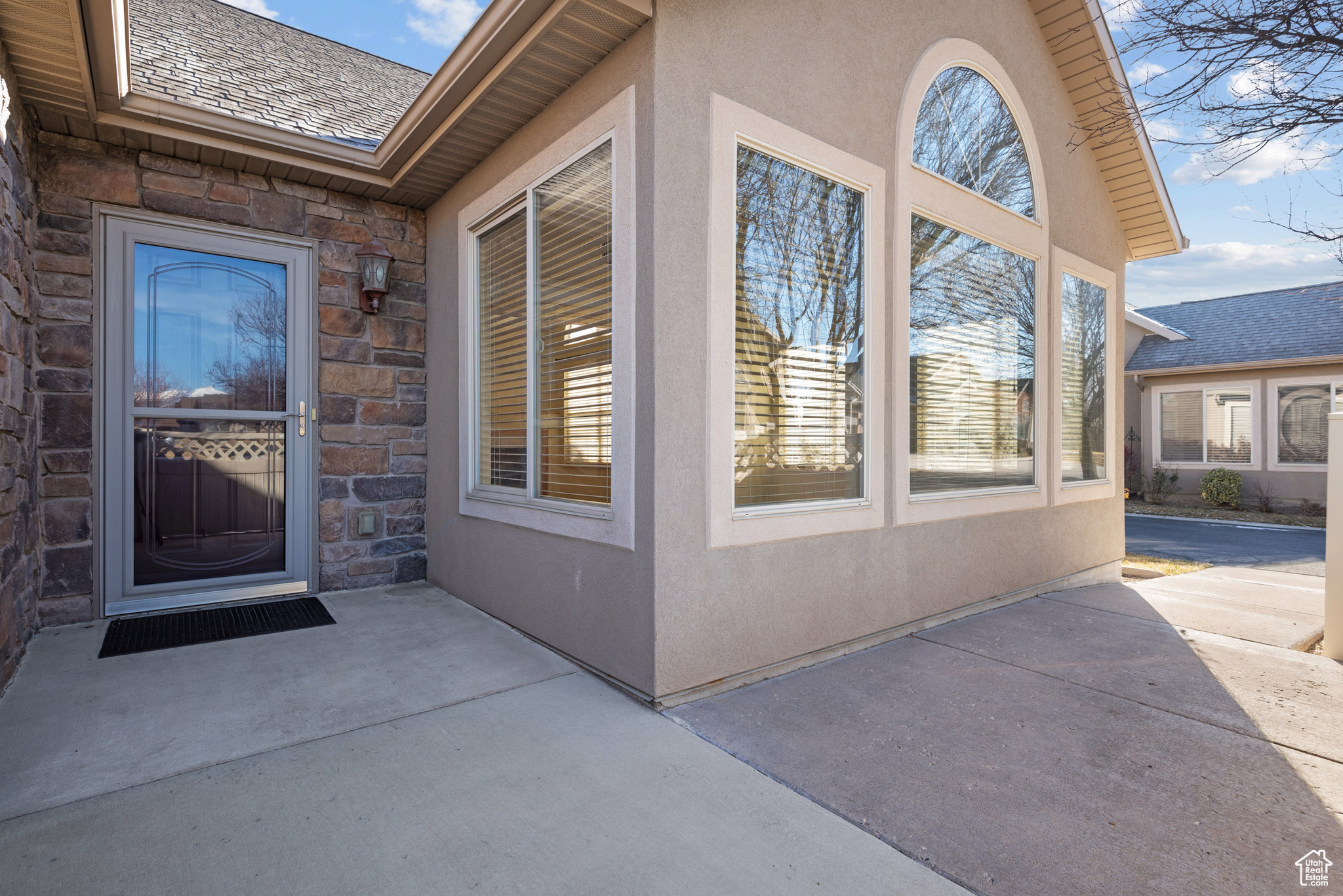 View of exterior entry featuring a patio area