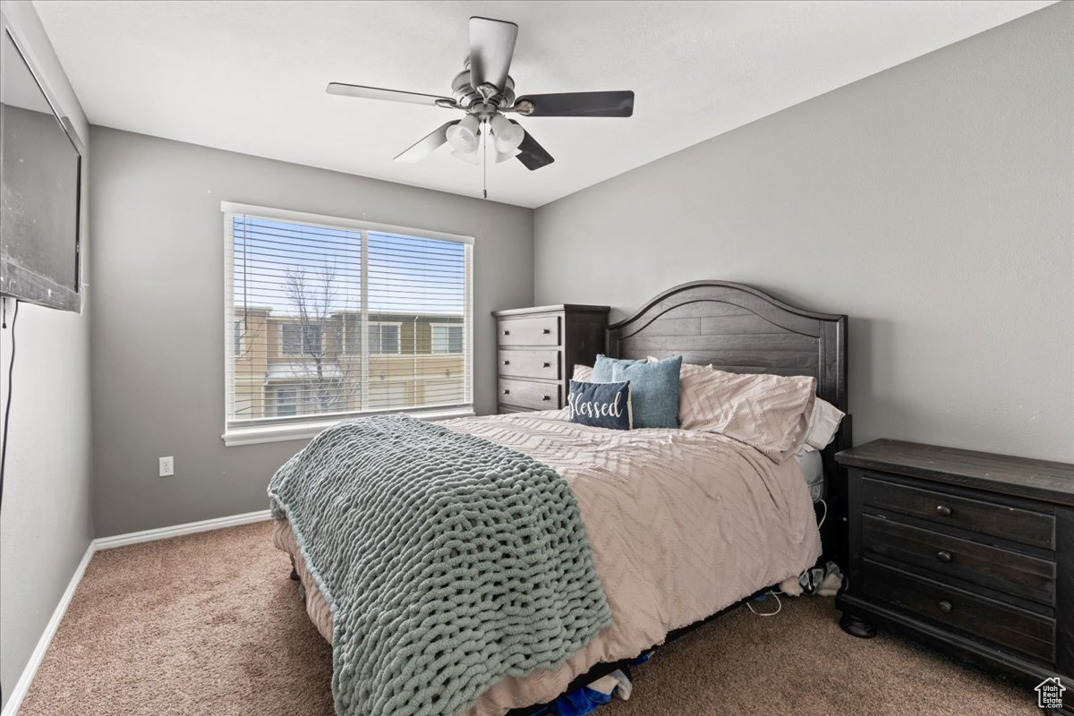 Bedroom featuring ceiling fan and carpet flooring