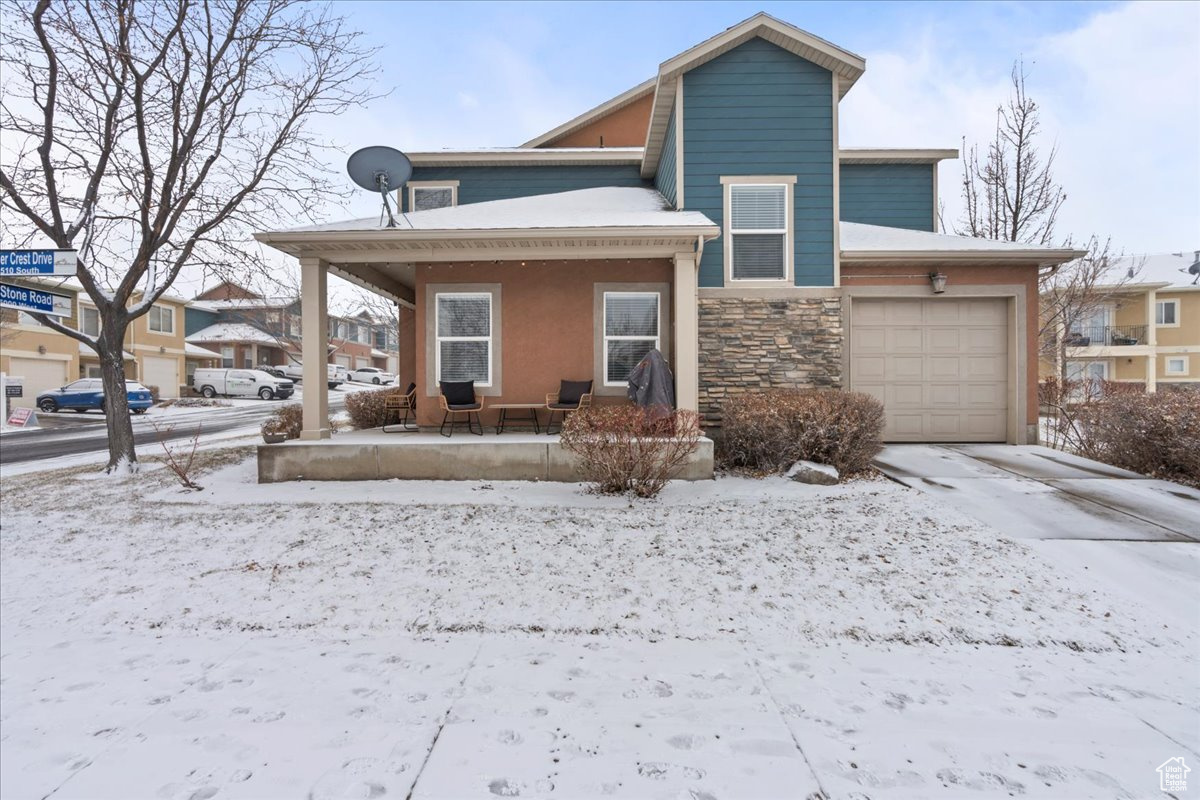 View of front facade with a garage and covered porch