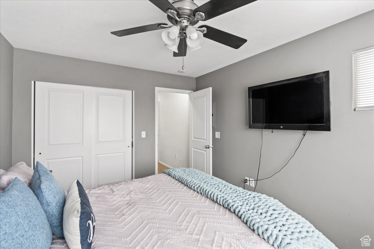 Bedroom with ceiling fan and a closet