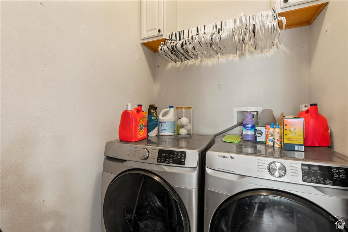 Washroom with washing machine and dryer and cabinets