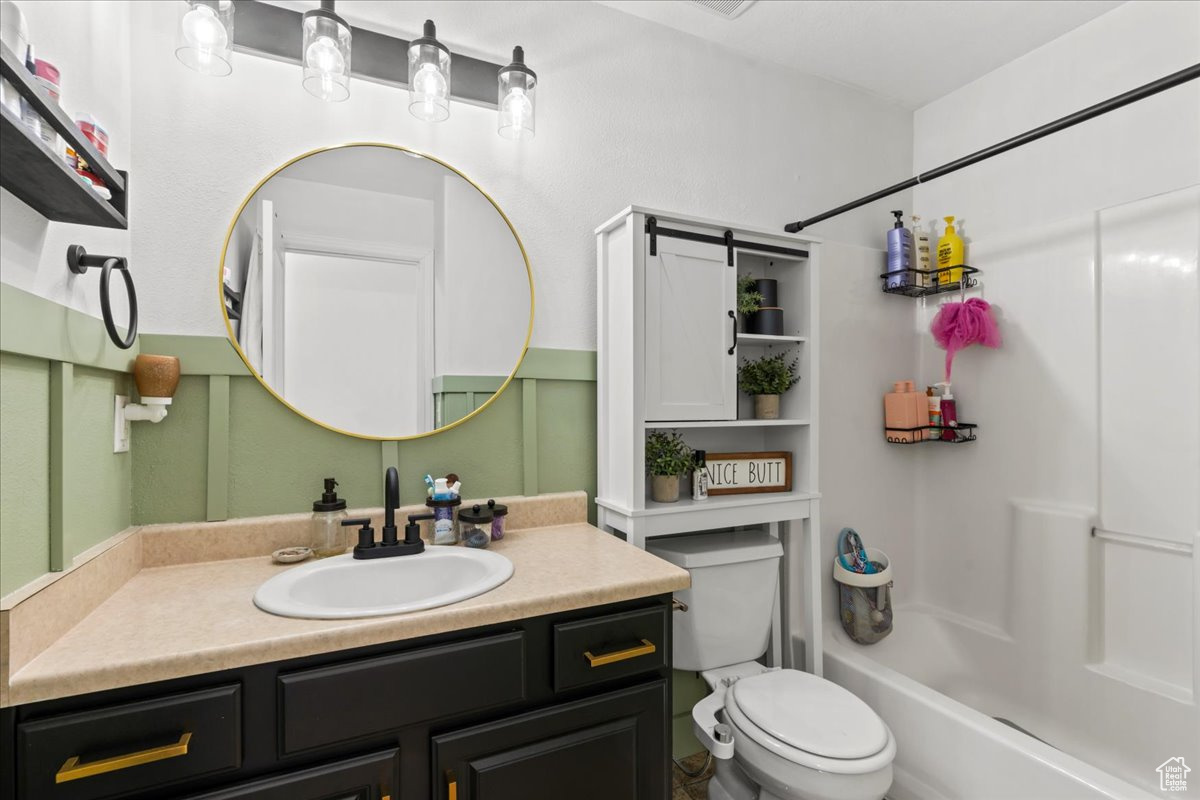 Full bathroom with shower / washtub combination, vanity, and toilet