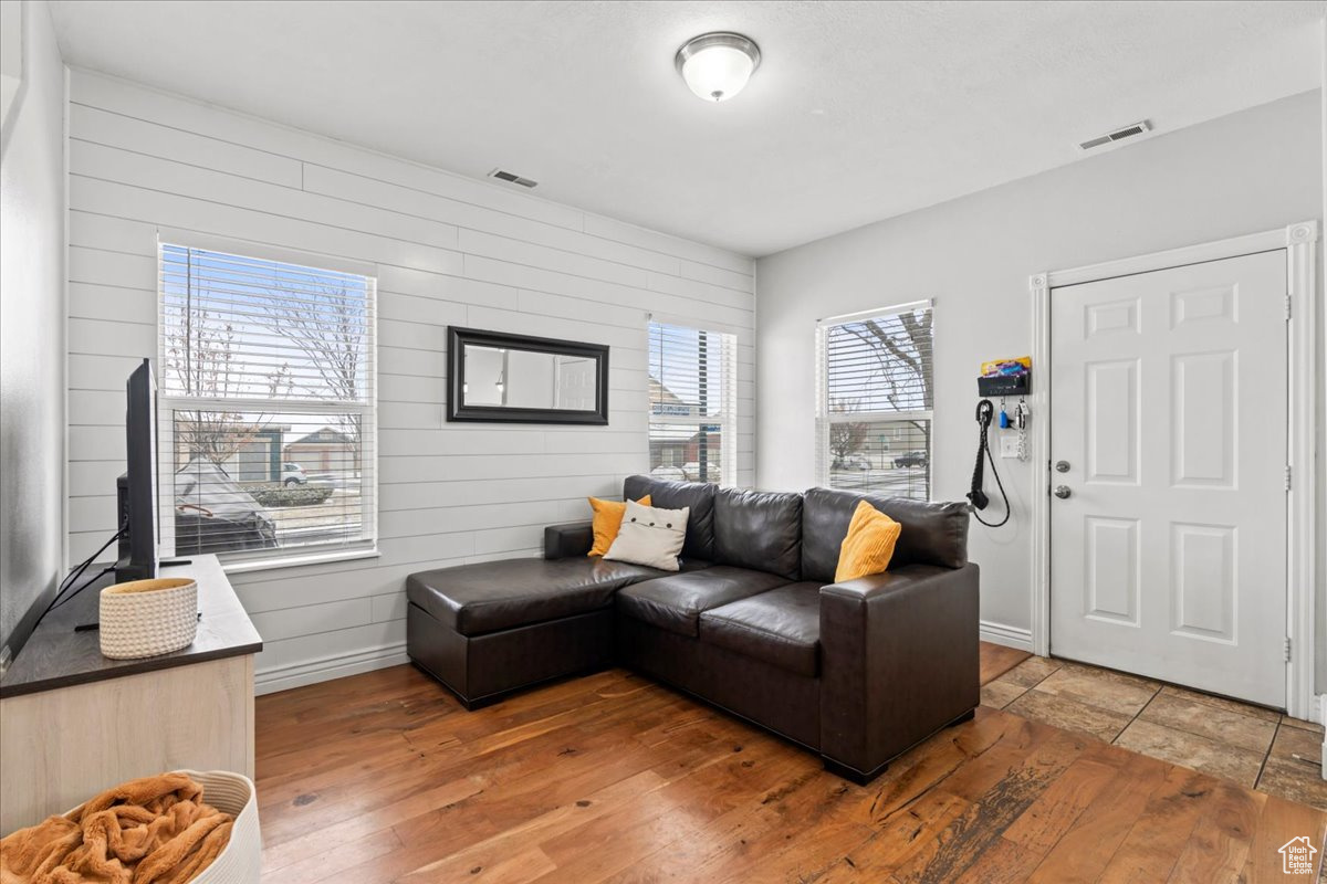 Living room with wood-type flooring and wood walls