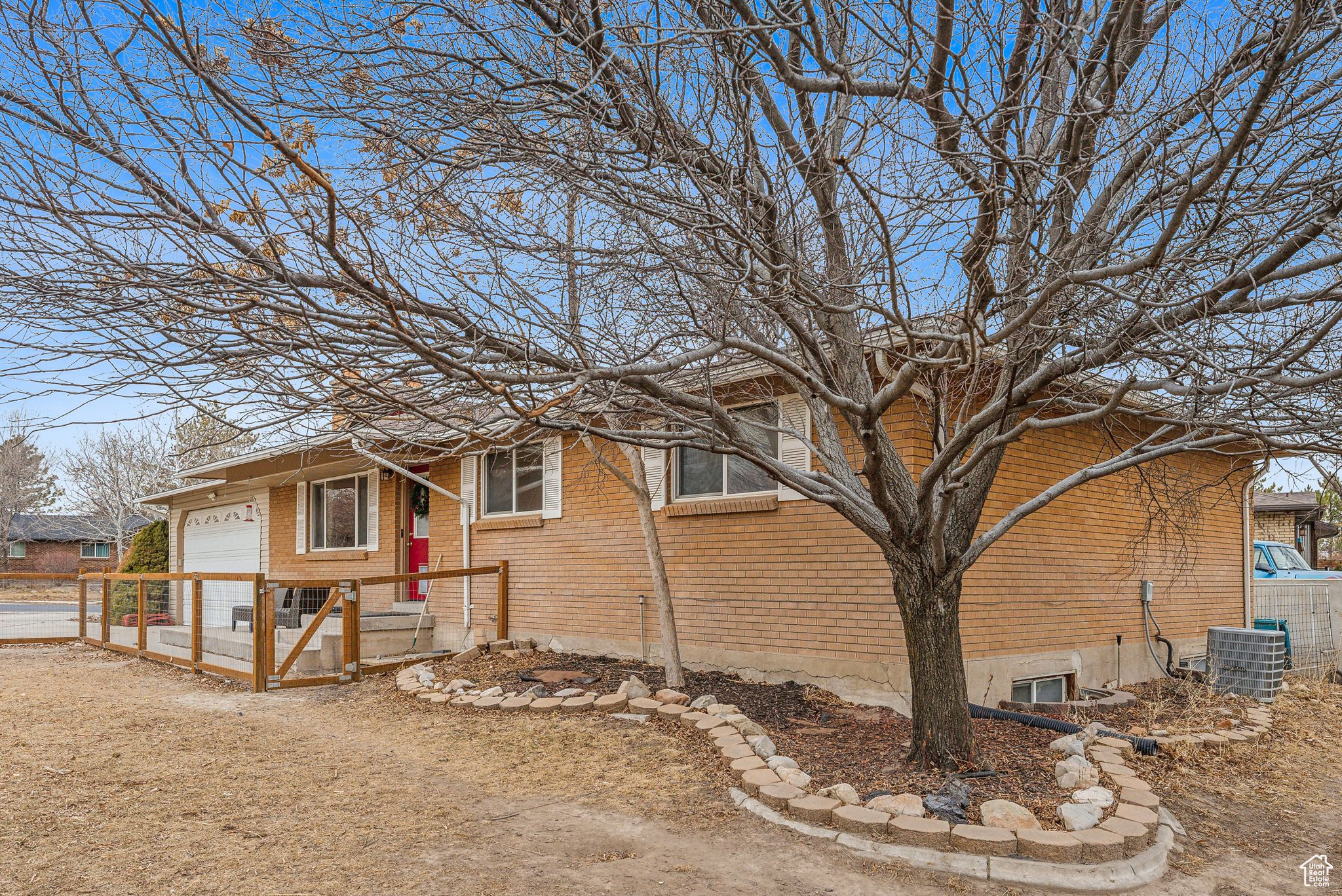 View of side of property with central AC and a garage