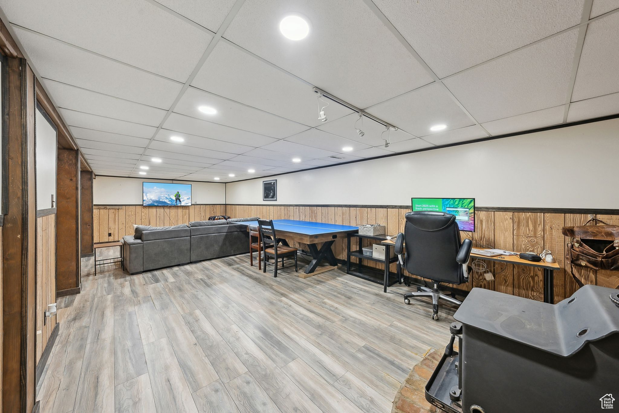 Office space featuring a paneled ceiling and light hardwood / wood-style flooring