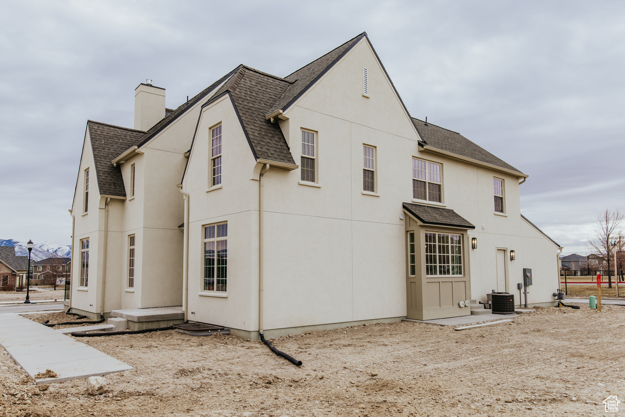 Rear view of house with a patio area and central air condition unit