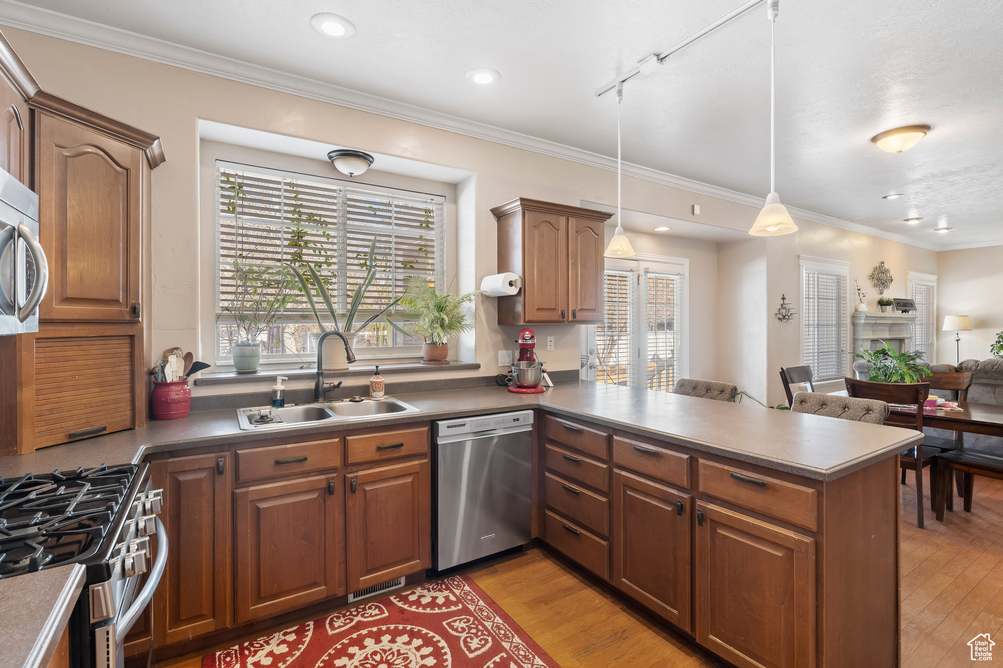 Spacious kitchen with large window shelf over the sink. Perfect place to grow your own herbs or favorite plants while looking into your backyard.