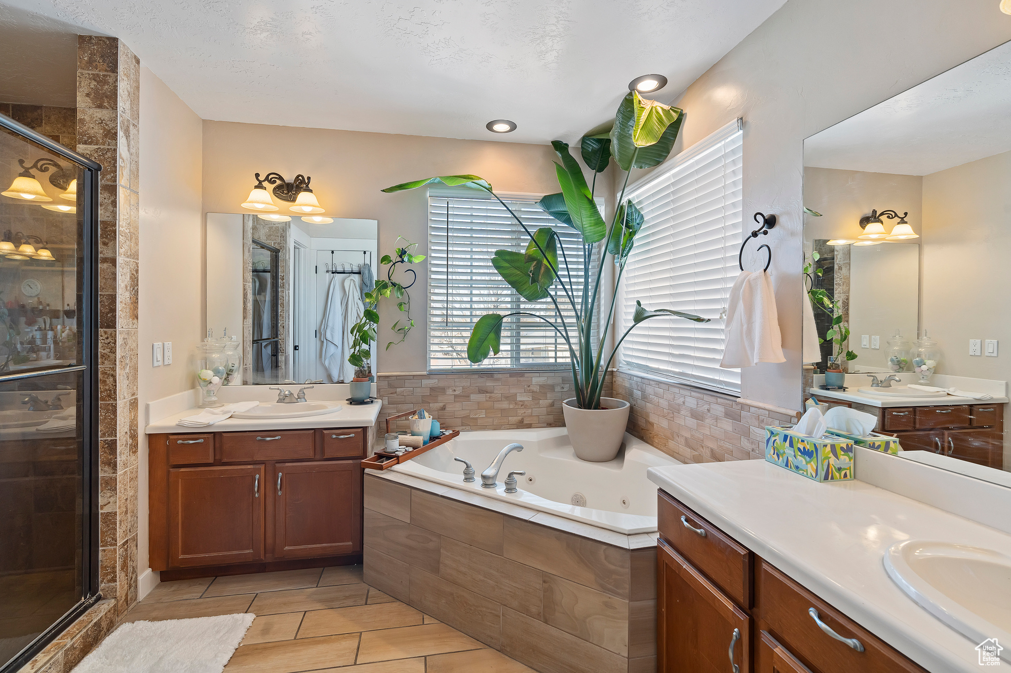 Corner jetted tub in Primary bathroom. The windows keep this bathroom light and bright.