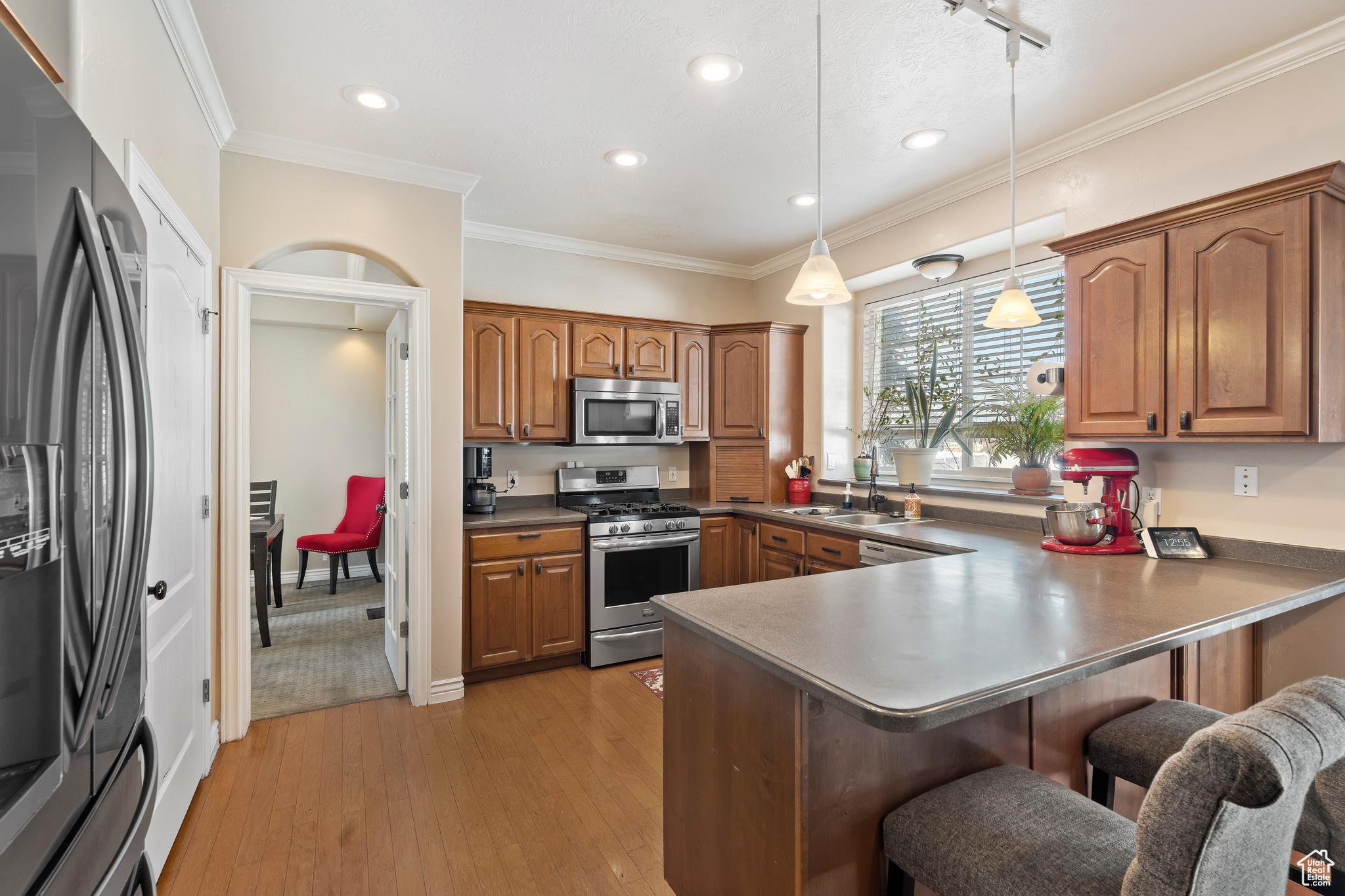 Spacious kitchen with large window shelf over the sink. Perfect place to grow your own herbs or favorite plants while looking into your backyard.