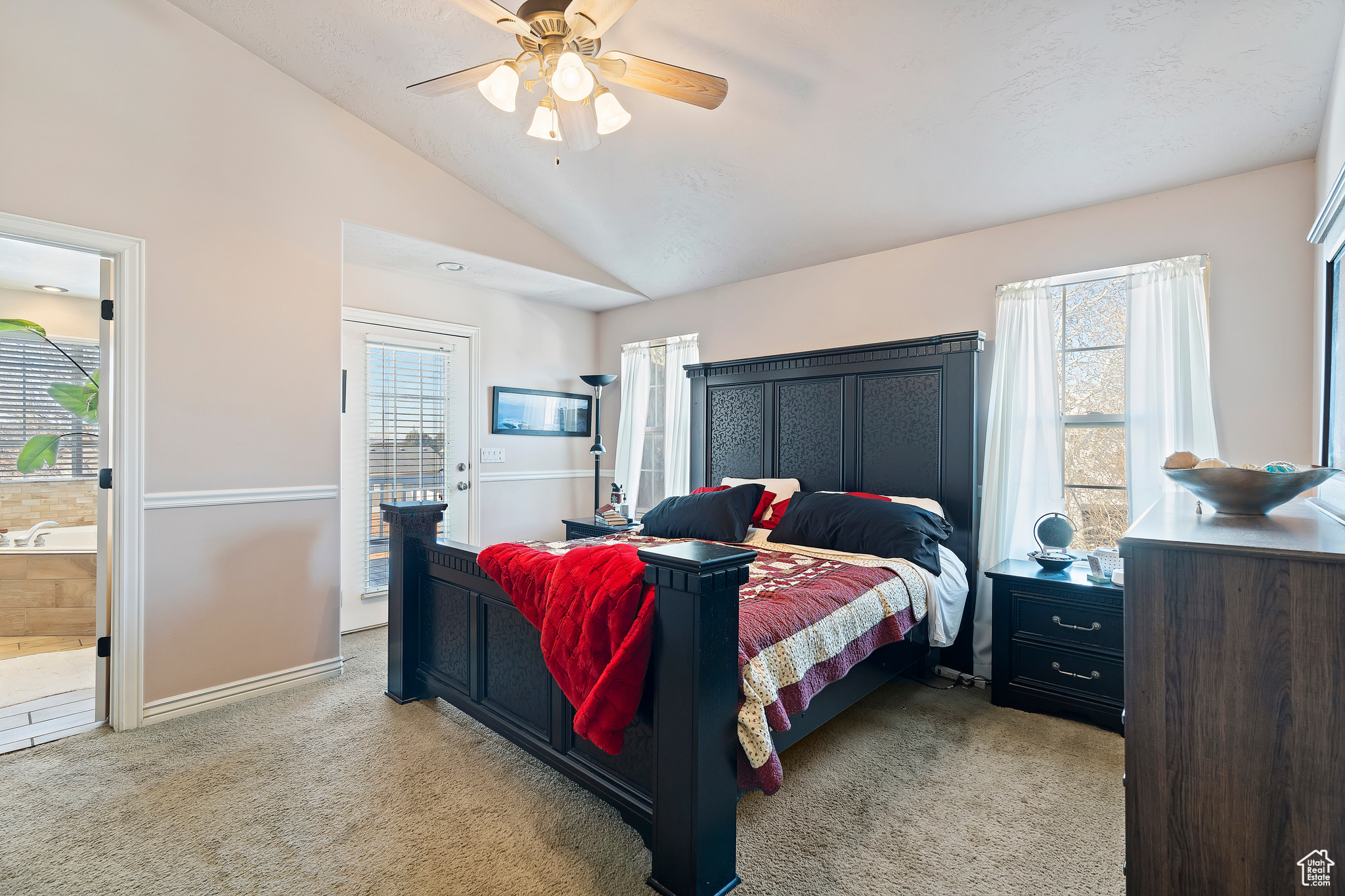 Primary bedroom showing door to the private balcony. The room has it's own bathroom with separate tub shower as well as a walk in closet.