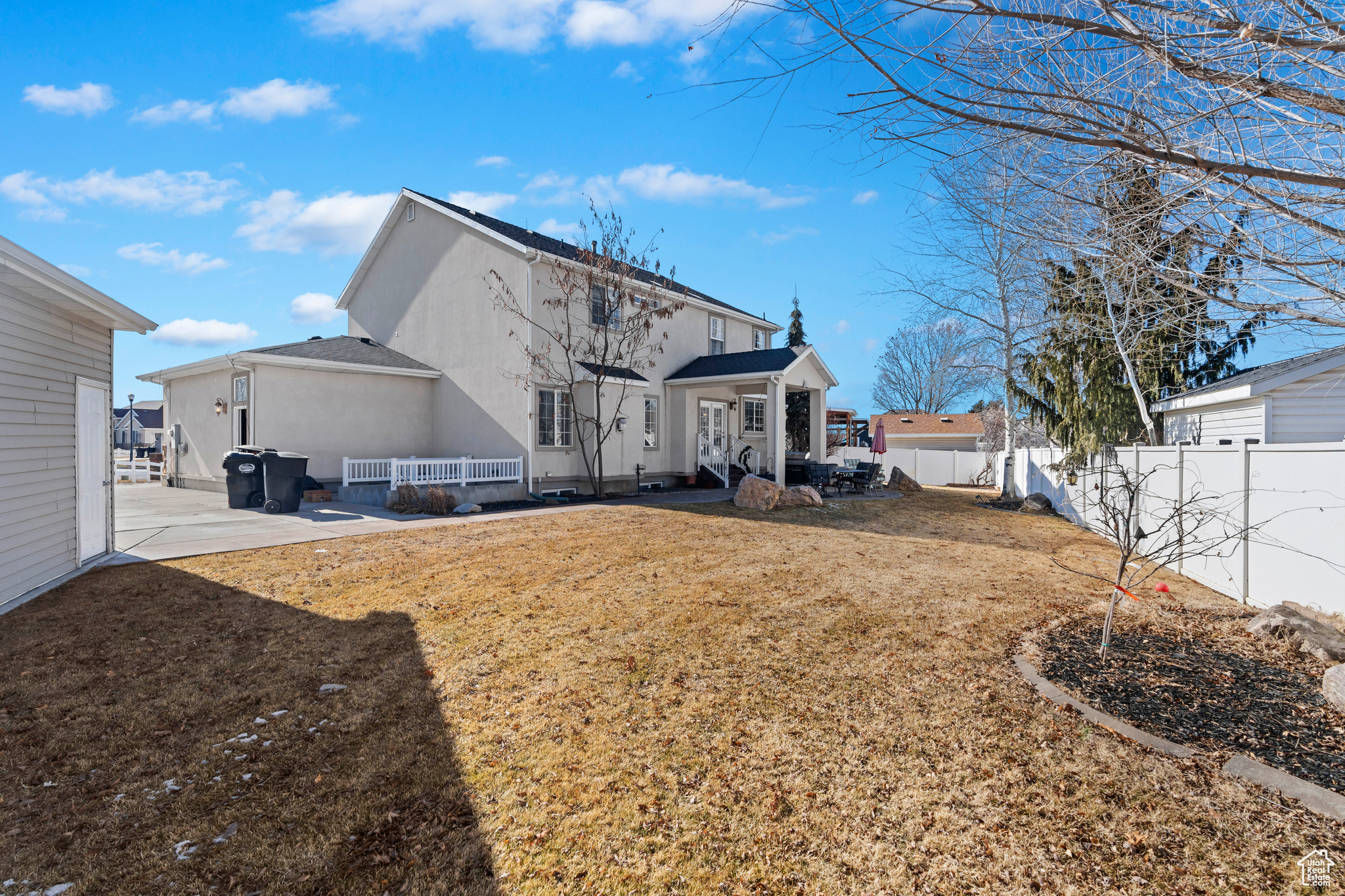 Rear view of property featuring a patio and a yard