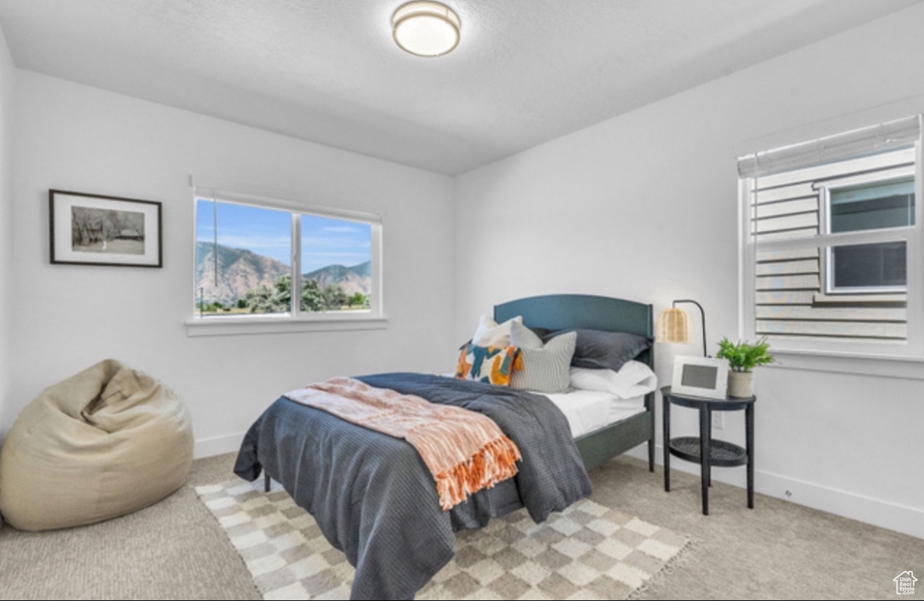 Bedroom featuring light colored carpet