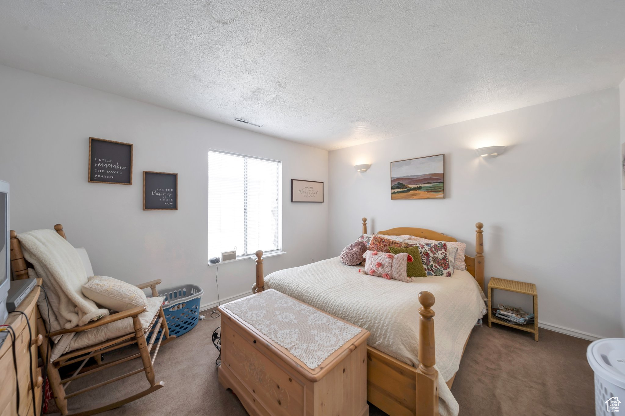 Carpeted bedroom featuring a textured ceiling