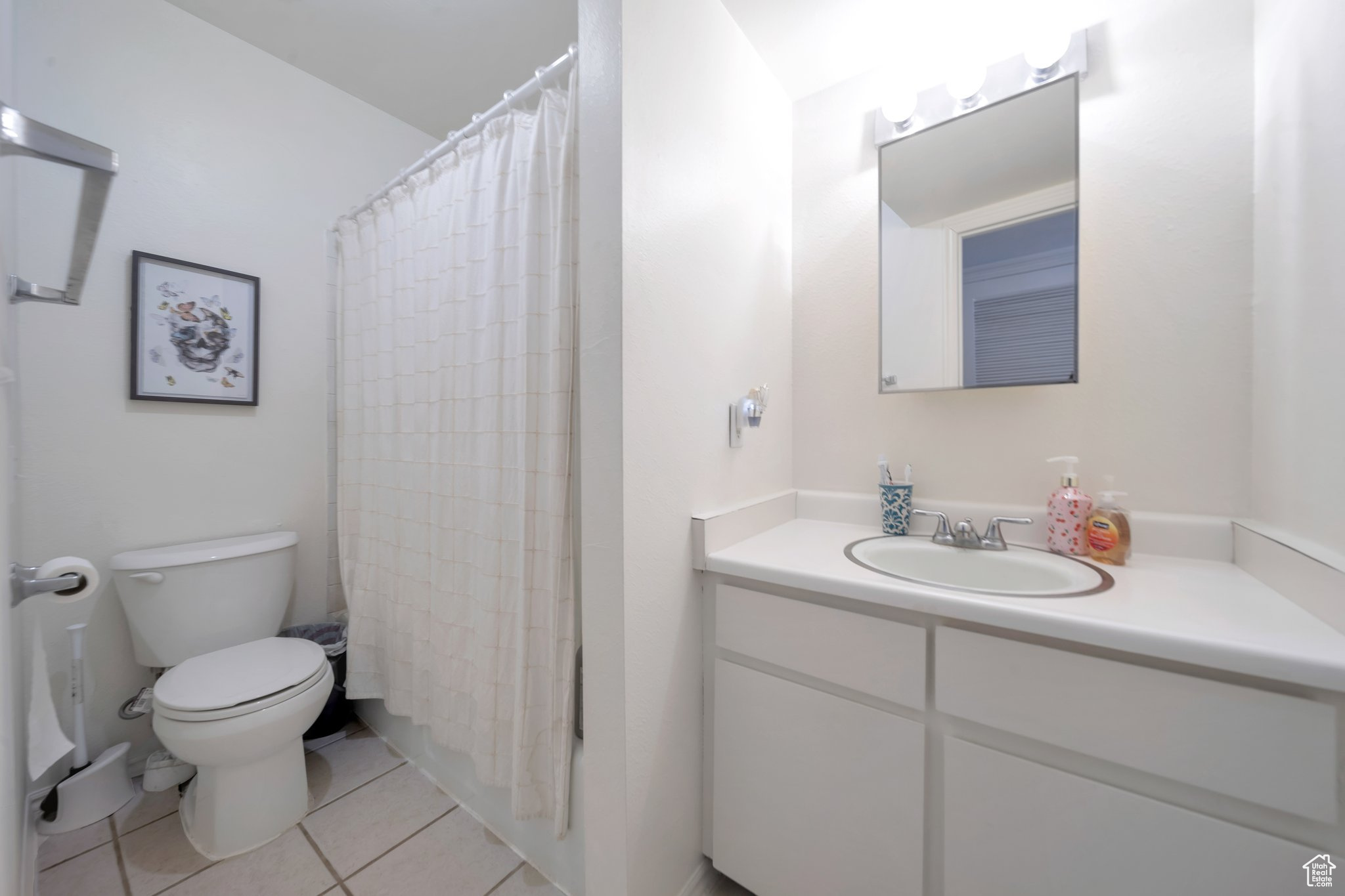 Bathroom featuring tile patterned flooring, vanity, and toilet