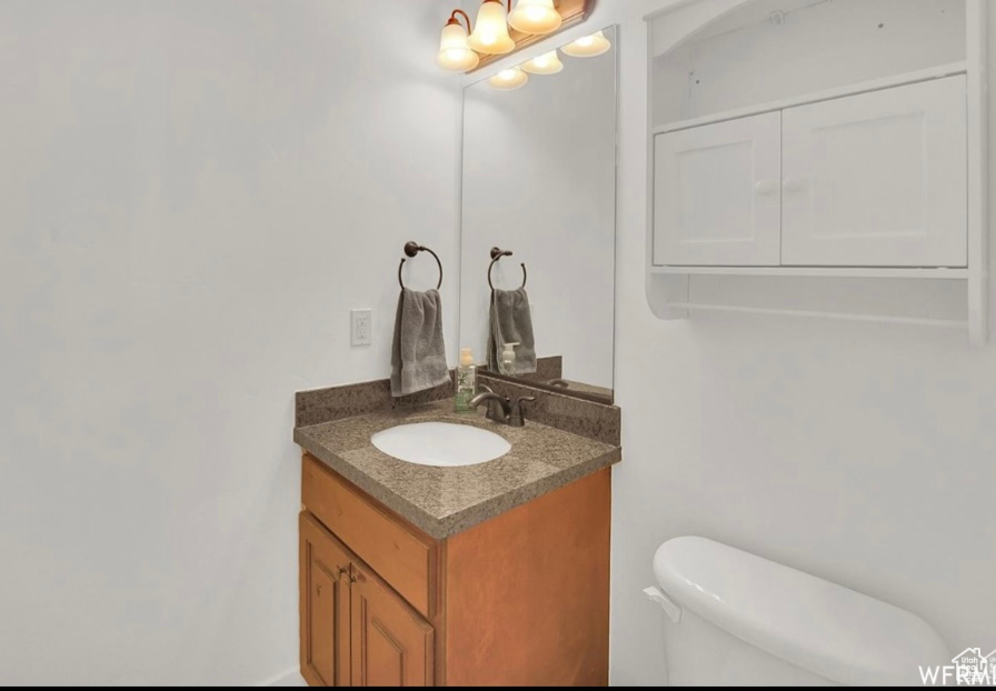 Bathroom featuring vanity and toilet