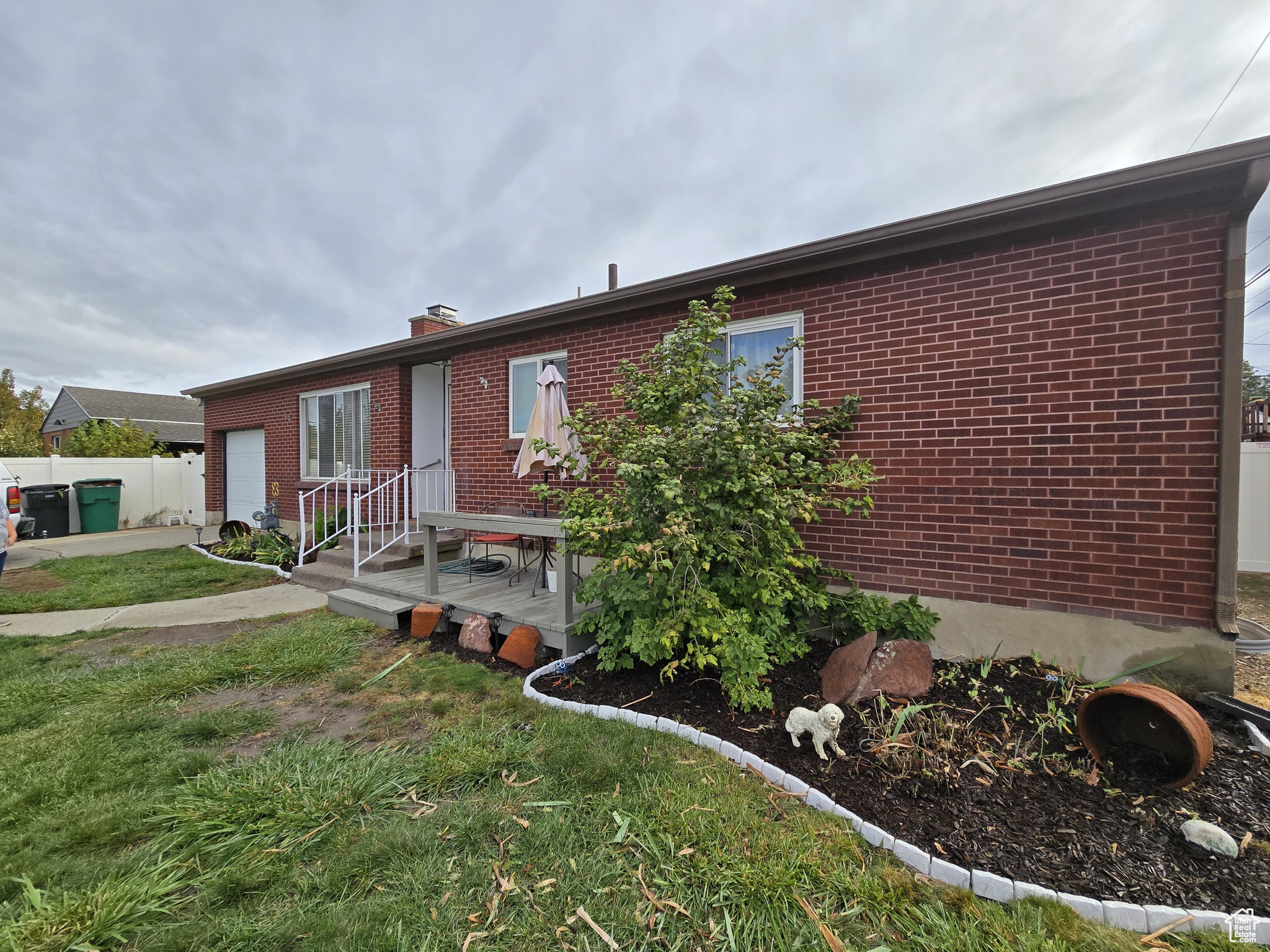 View of front facade with a garage and a front lawn