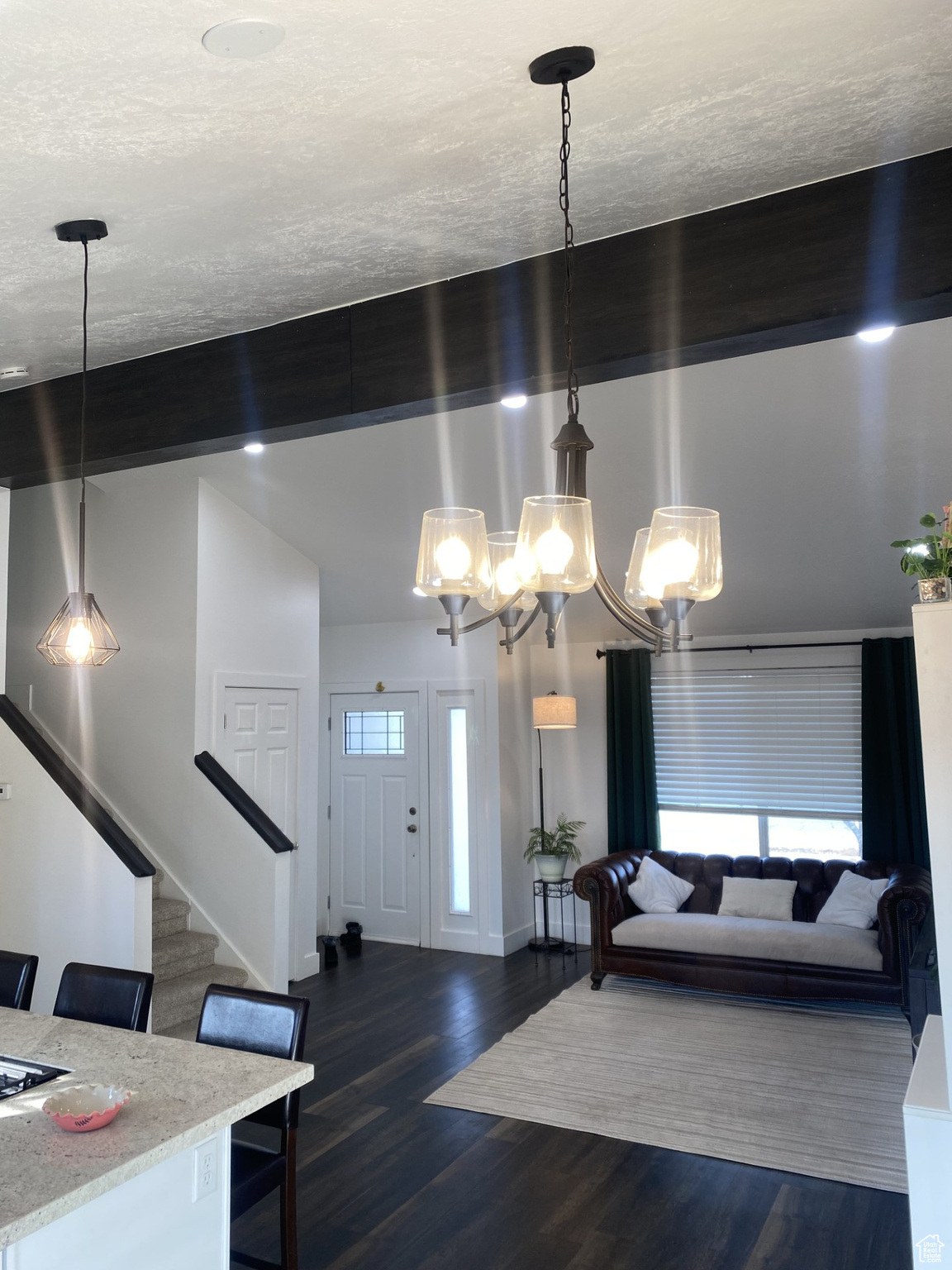 Living room featuring dark hardwood / wood-style floors and beamed ceiling