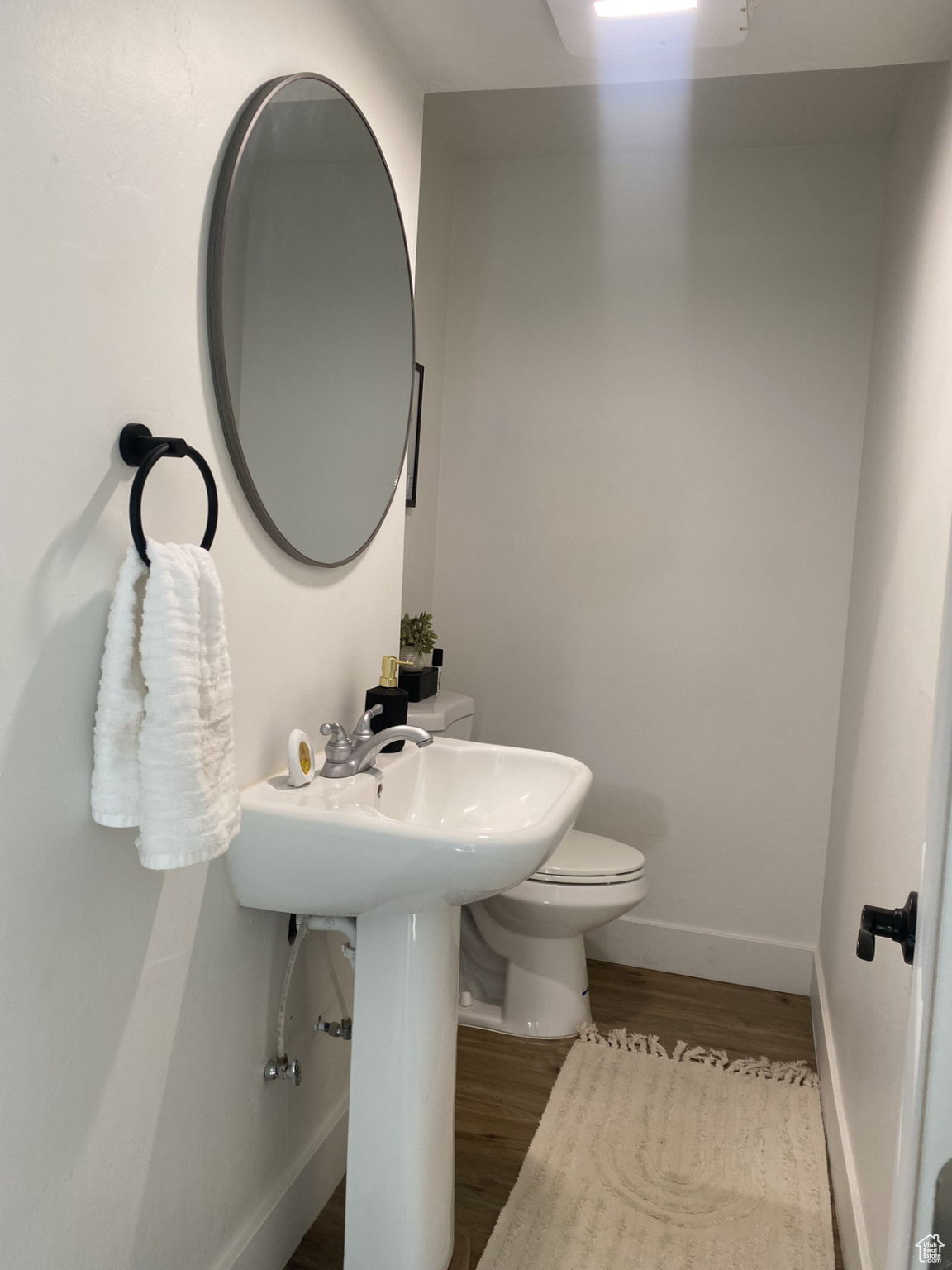 Bathroom featuring wood-type flooring and toilet