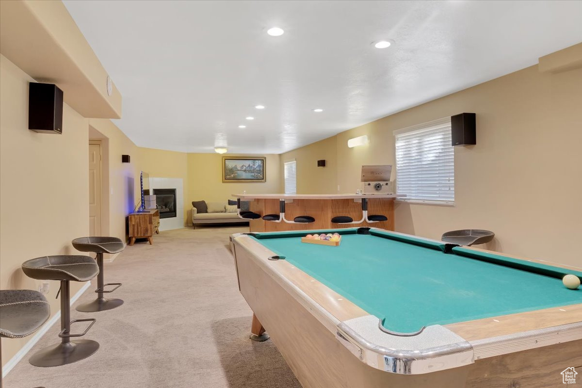 Playroom with pool table and light colored carpet