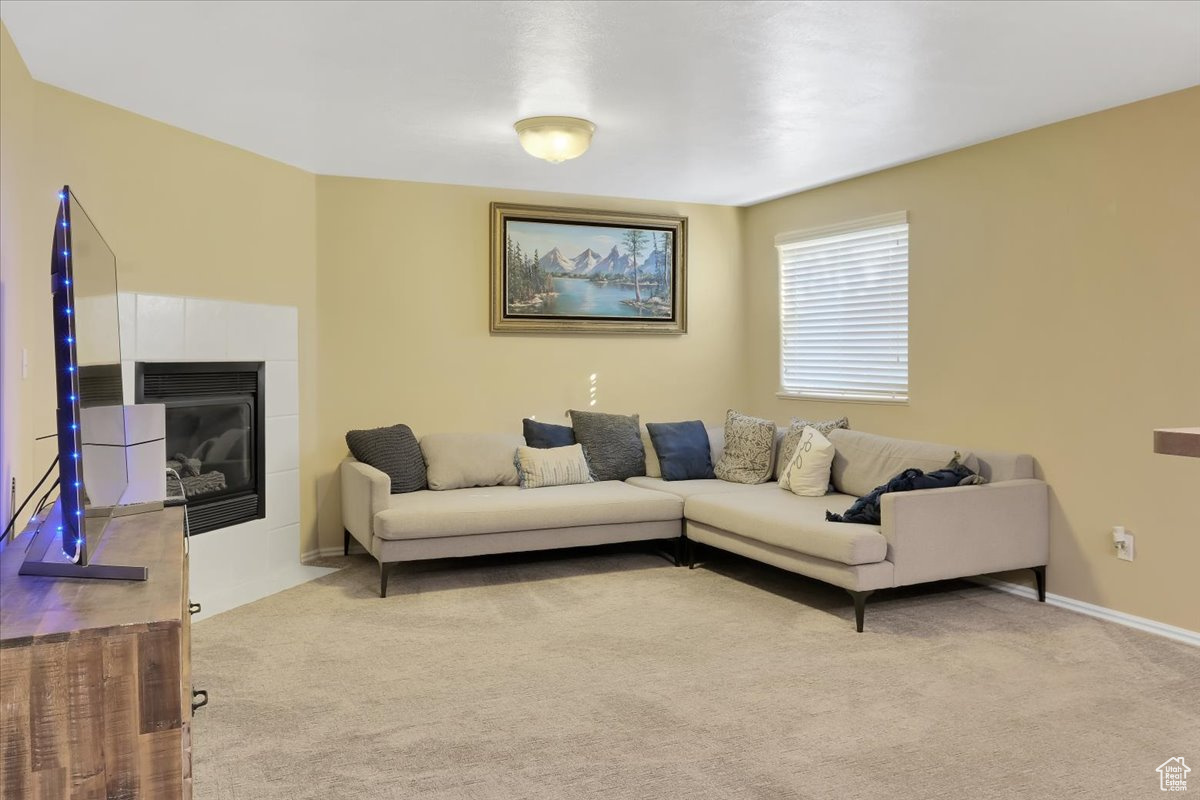 Living room with a fireplace and light colored carpet